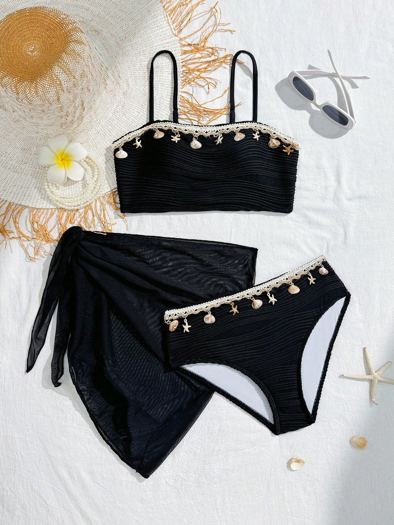 Tween girls bikini set with shell and starfish woven band details, spaghetti strap sleeveless top, and mid-waist skirt-style bottom in blue.