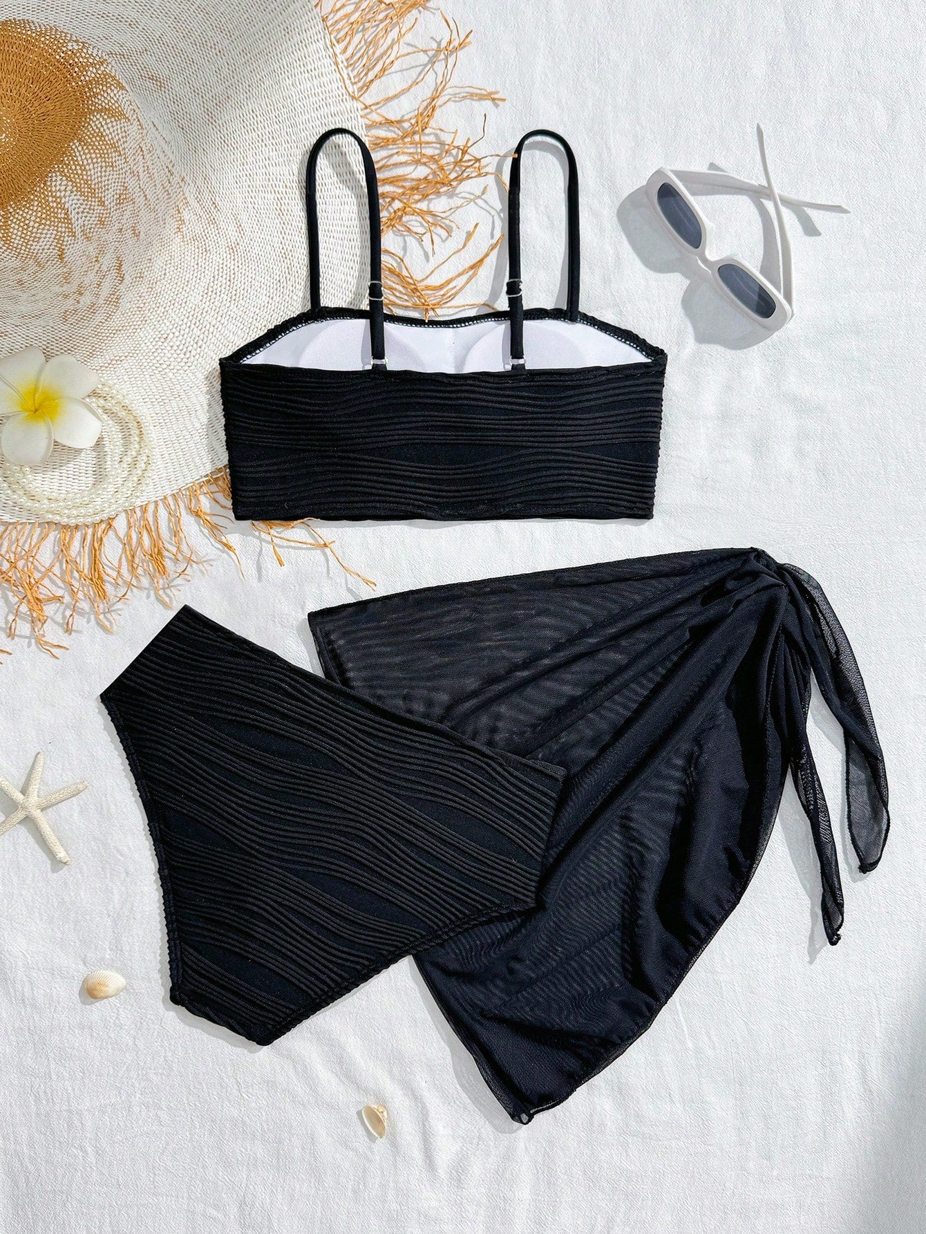 Tween girls bikini set with shell and starfish woven band details, spaghetti strap sleeveless top, and mid-waist skirt-style bottom in blue.