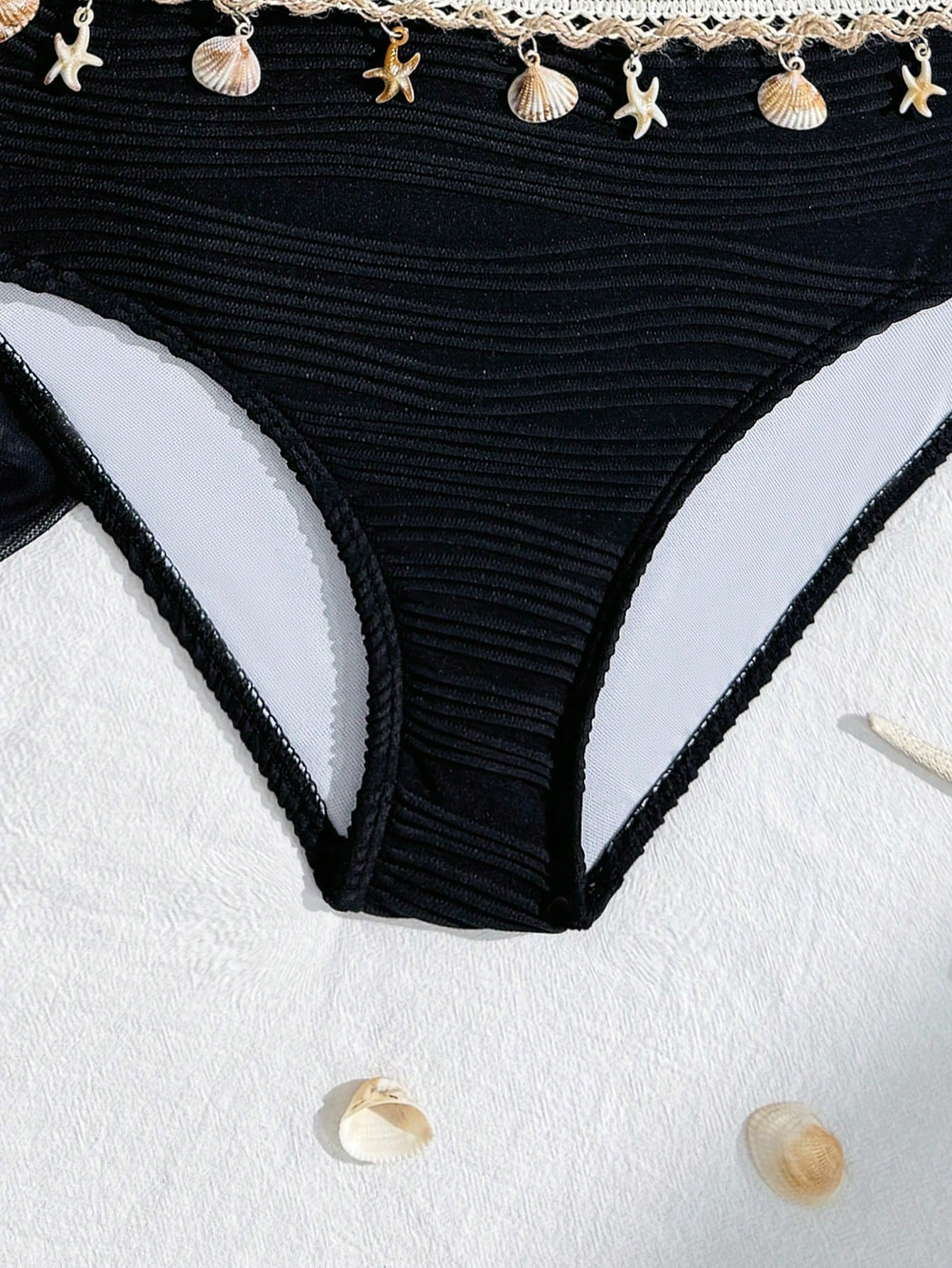 Tween girls bikini set with shell and starfish woven band details, spaghetti strap sleeveless top, and mid-waist skirt-style bottom in blue.