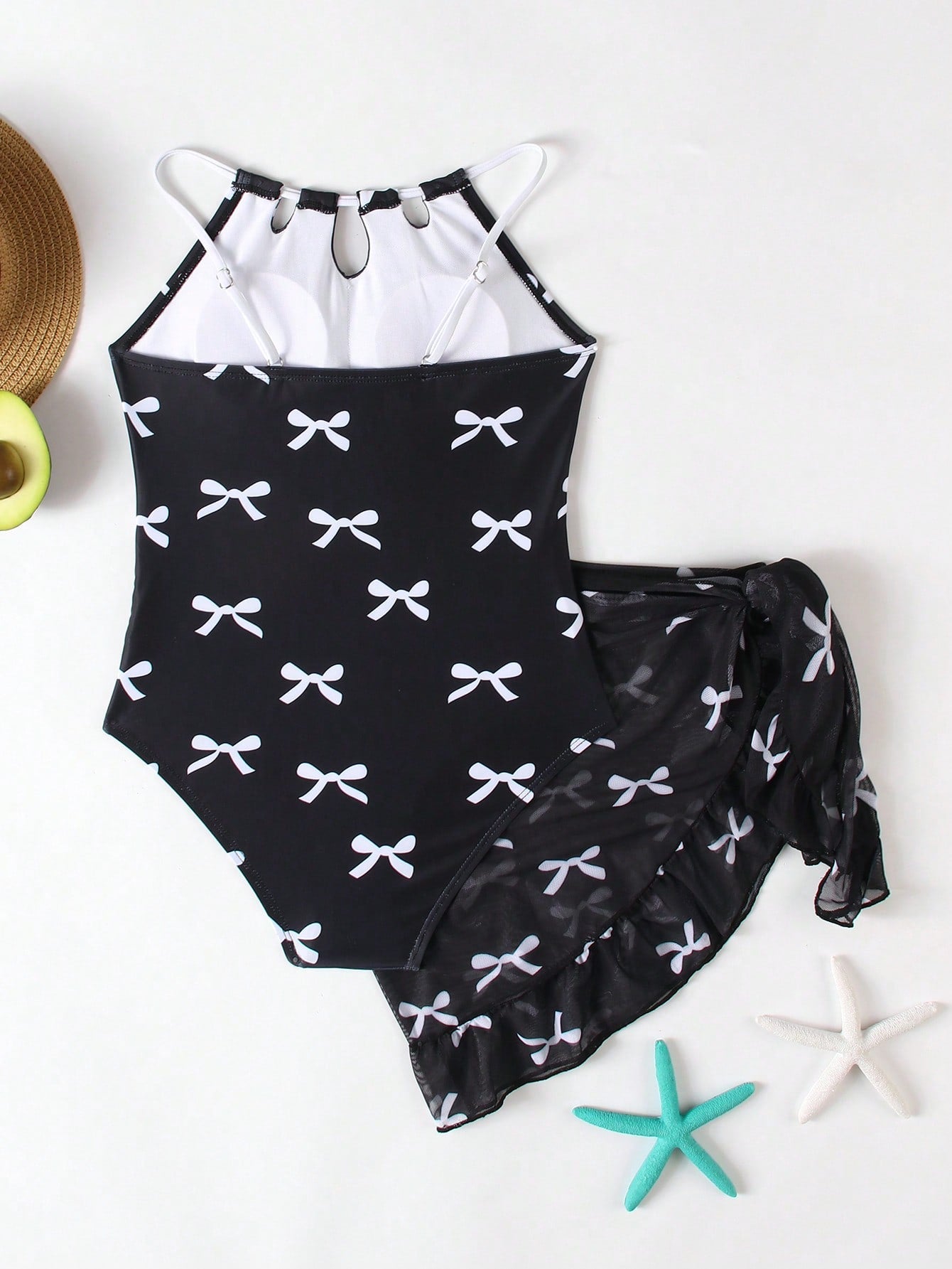 Girls black and white one-piece swimsuit set with cut-out detail, spaghetti straps, sleeveless fitted design, and matching skirt bottom for vacation swimwear.