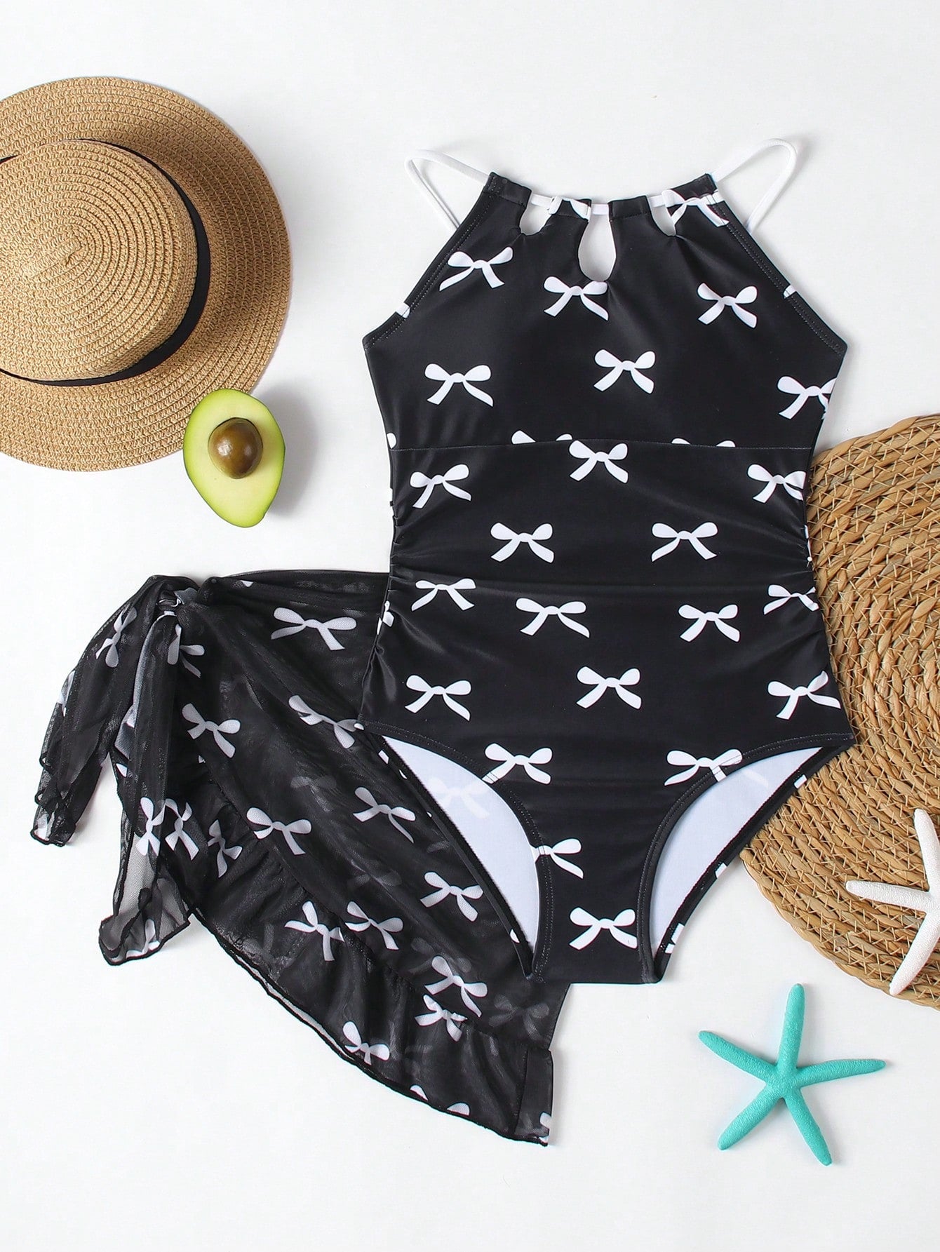 Girls black and white one-piece swimsuit set with cut-out detail, spaghetti straps, sleeveless fitted design, and matching skirt bottom for vacation swimwear.