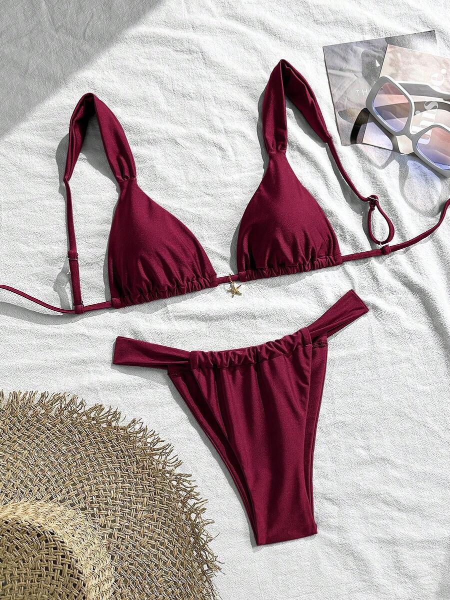 Women's 2-piece triangle cup bikini set in solid color featuring woven pearl shell decoration, halter neckline, and high-waist side-tie ruched bottoms.