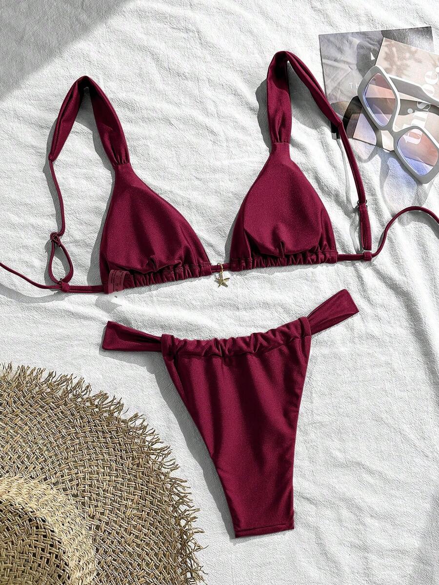 Women's 2-piece triangle cup bikini set in solid color featuring woven pearl shell decoration, halter neckline, and high-waist side-tie ruched bottoms.
