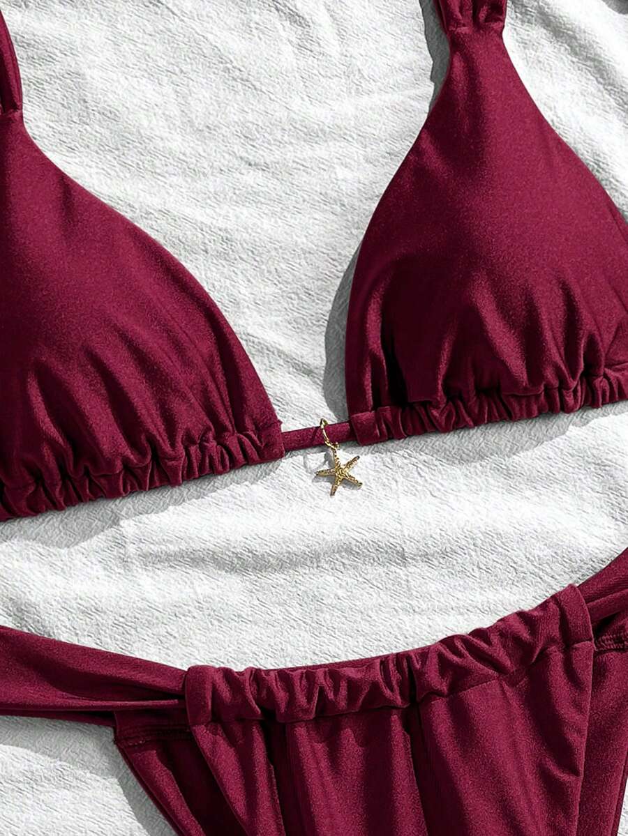 Women's 2-piece triangle cup bikini set in solid color featuring woven pearl shell decoration, halter neckline, and high-waist side-tie ruched bottoms.