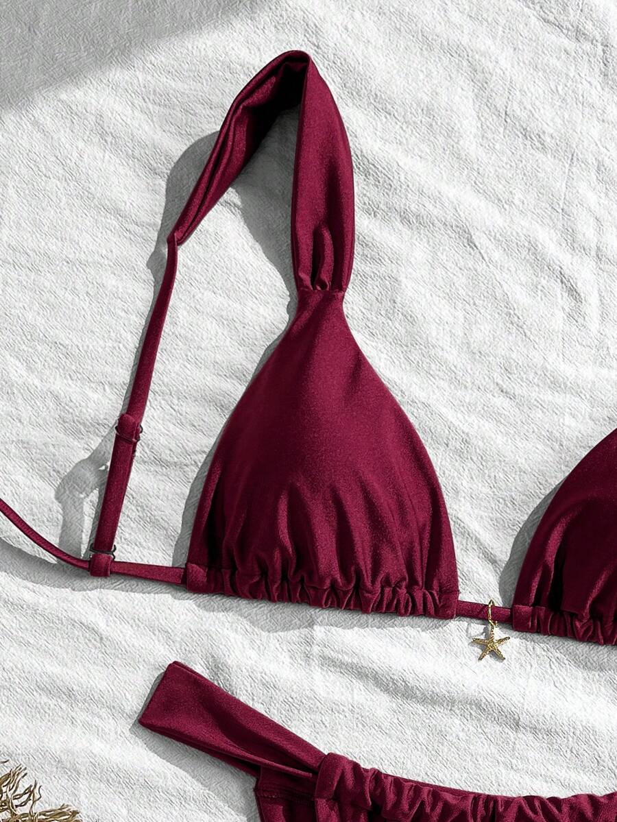 Women's 2-piece triangle cup bikini set in solid color featuring woven pearl shell decoration, halter neckline, and high-waist side-tie ruched bottoms.