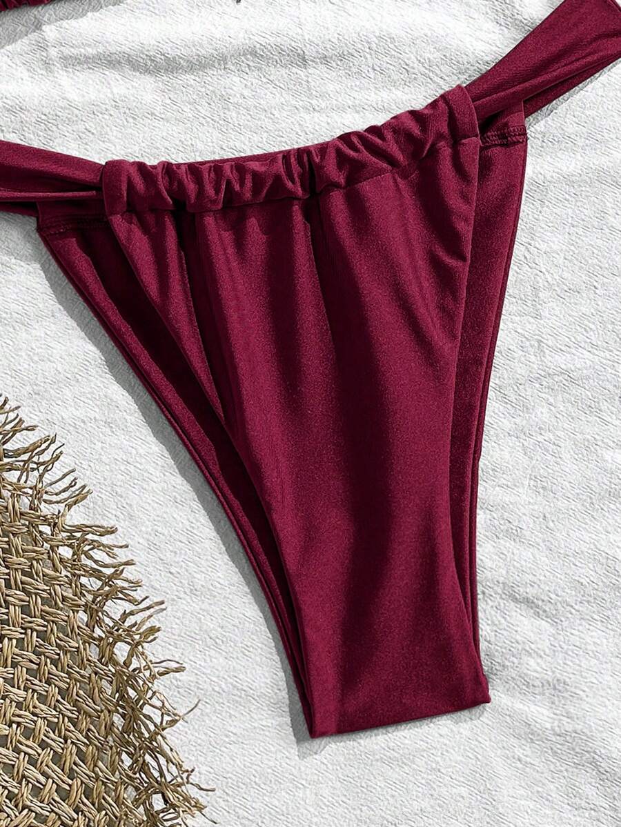 Women's 2-piece triangle cup bikini set in solid color featuring woven pearl shell decoration, halter neckline, and high-waist side-tie ruched bottoms.