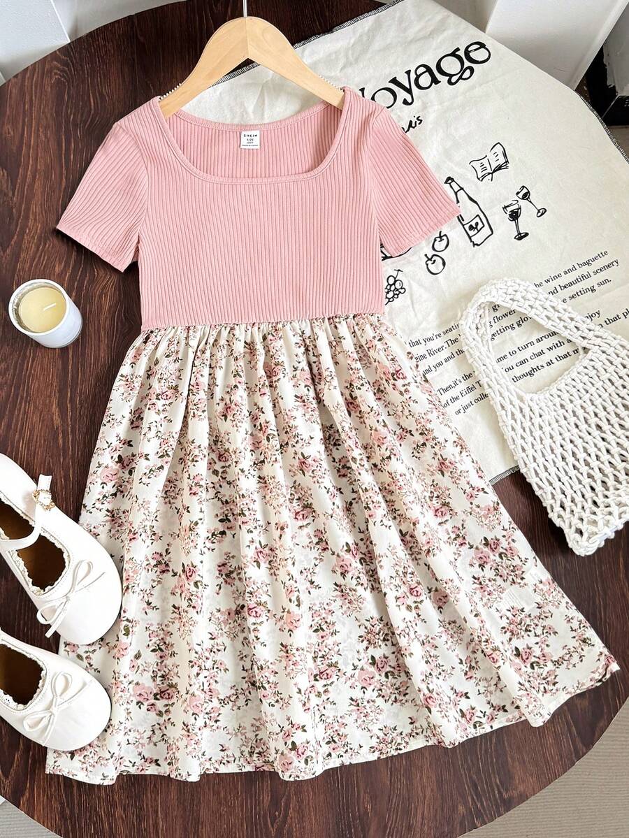 Tween girl wearing an apricot short sleeve A-line dress featuring a round neck, high waist with a belt, and flared hem.