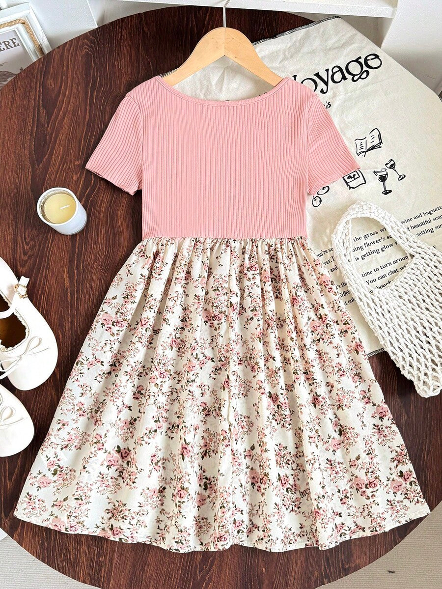 Tween girl wearing an apricot short sleeve A-line dress featuring a round neck, high waist with a belt, and flared hem.