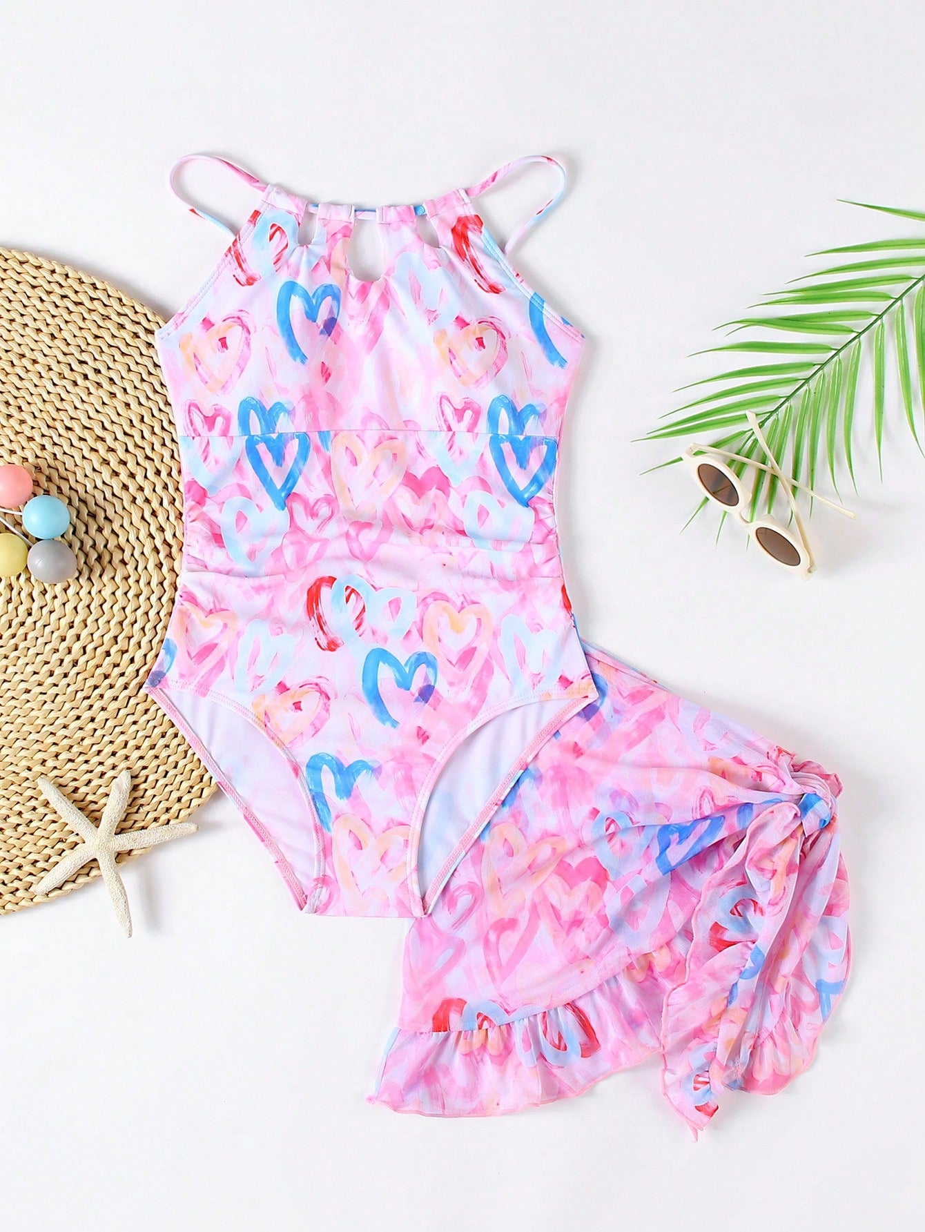 Girls black and white one-piece swimsuit set with cut-out detail, spaghetti straps, sleeveless fitted design, and matching skirt bottom for vacation swimwear.