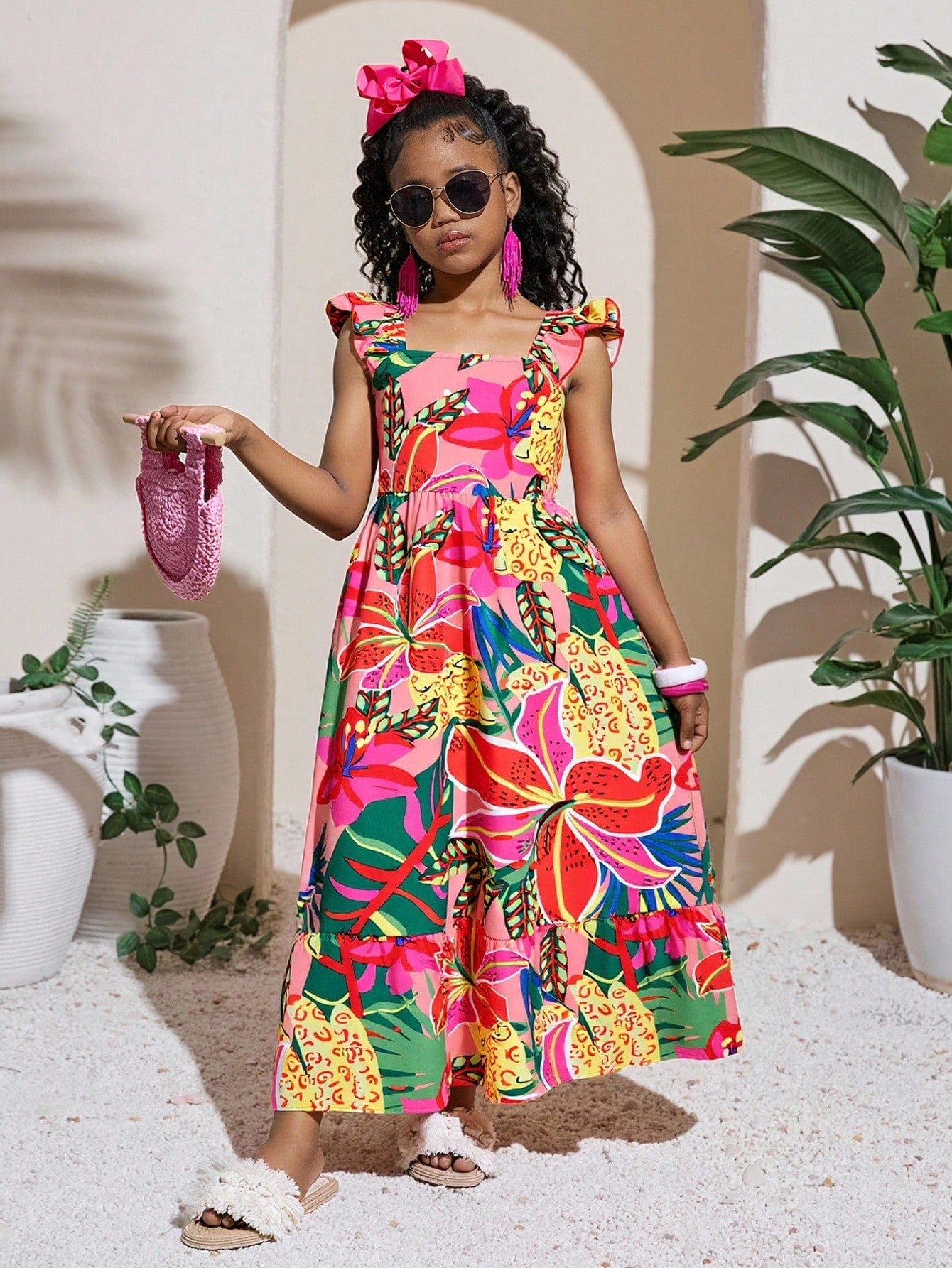 Tween girl multicolor floral vacation dress with square neck, ruffle details, shirred bodice, sleeveless A-line shape, high waist, and flounce hem.