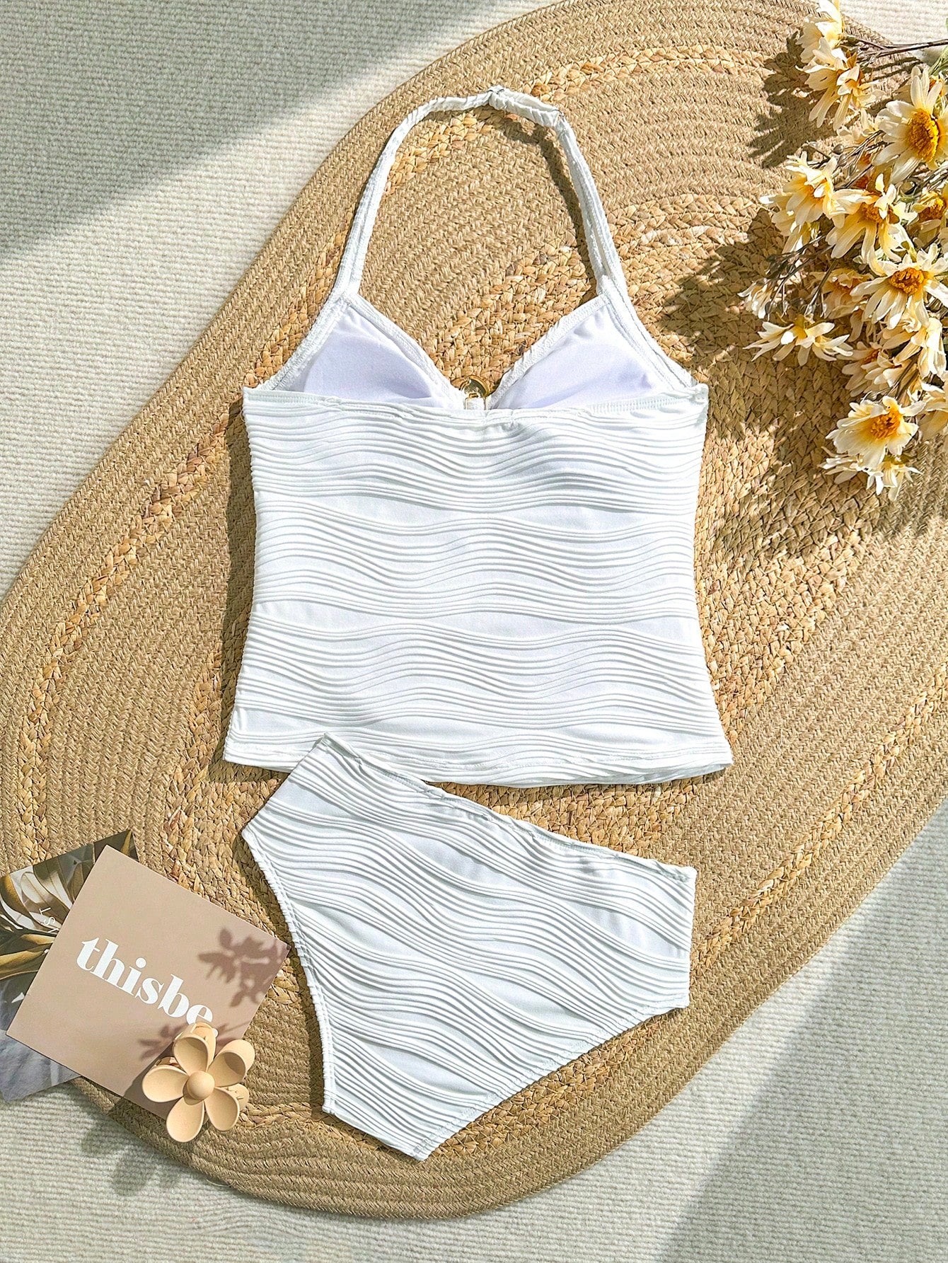 Tween girls 2-piece bikini swimwear set in black with a wave-pattern geometric design, featuring halter neckline, wireless top, and high-waist short bottoms with starfish and shell decor.