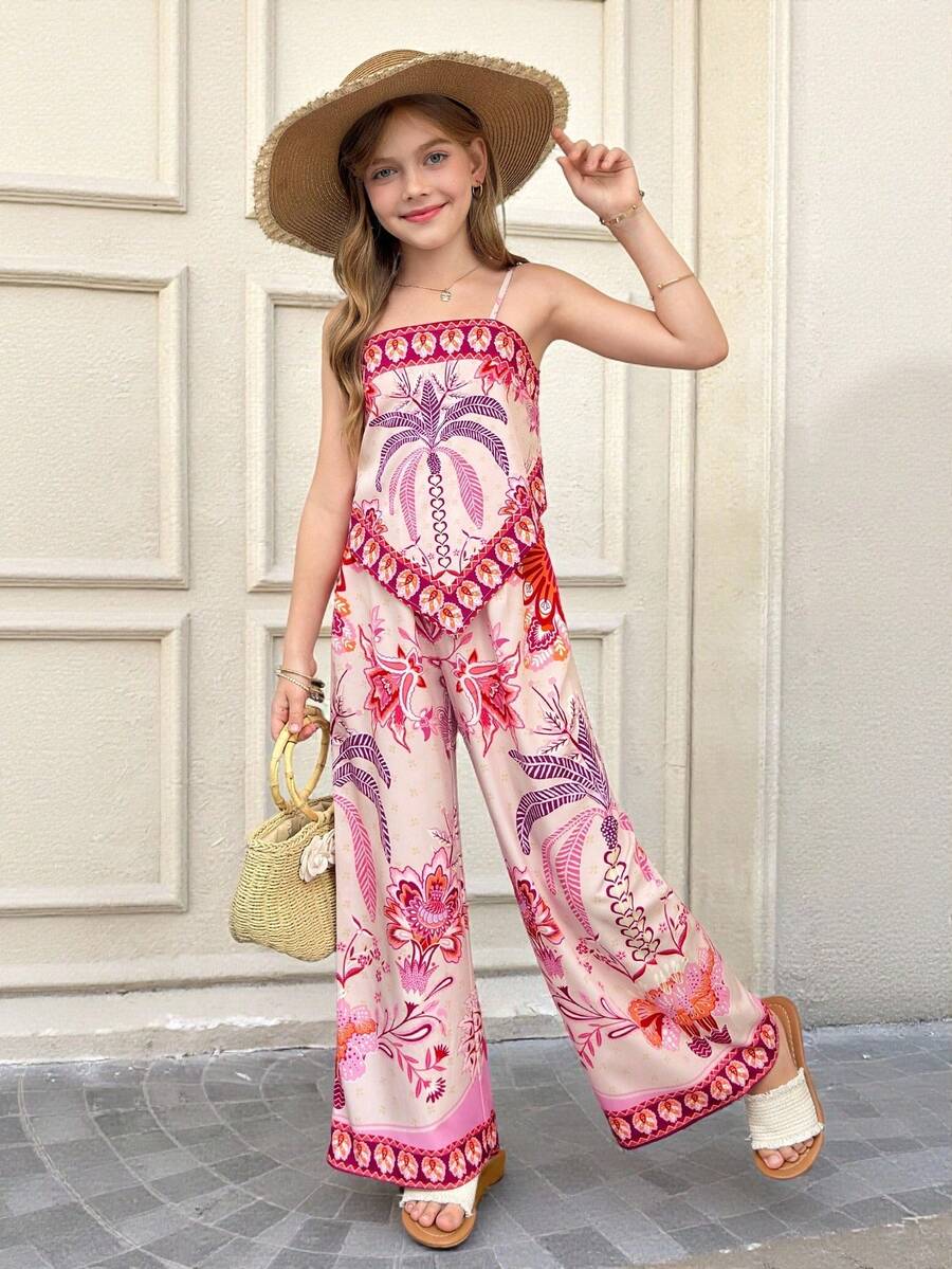Tween girl wearing a pink boho floral printed 2-piece set with a spaghetti strap cami top and matching belted high-waist long pants.