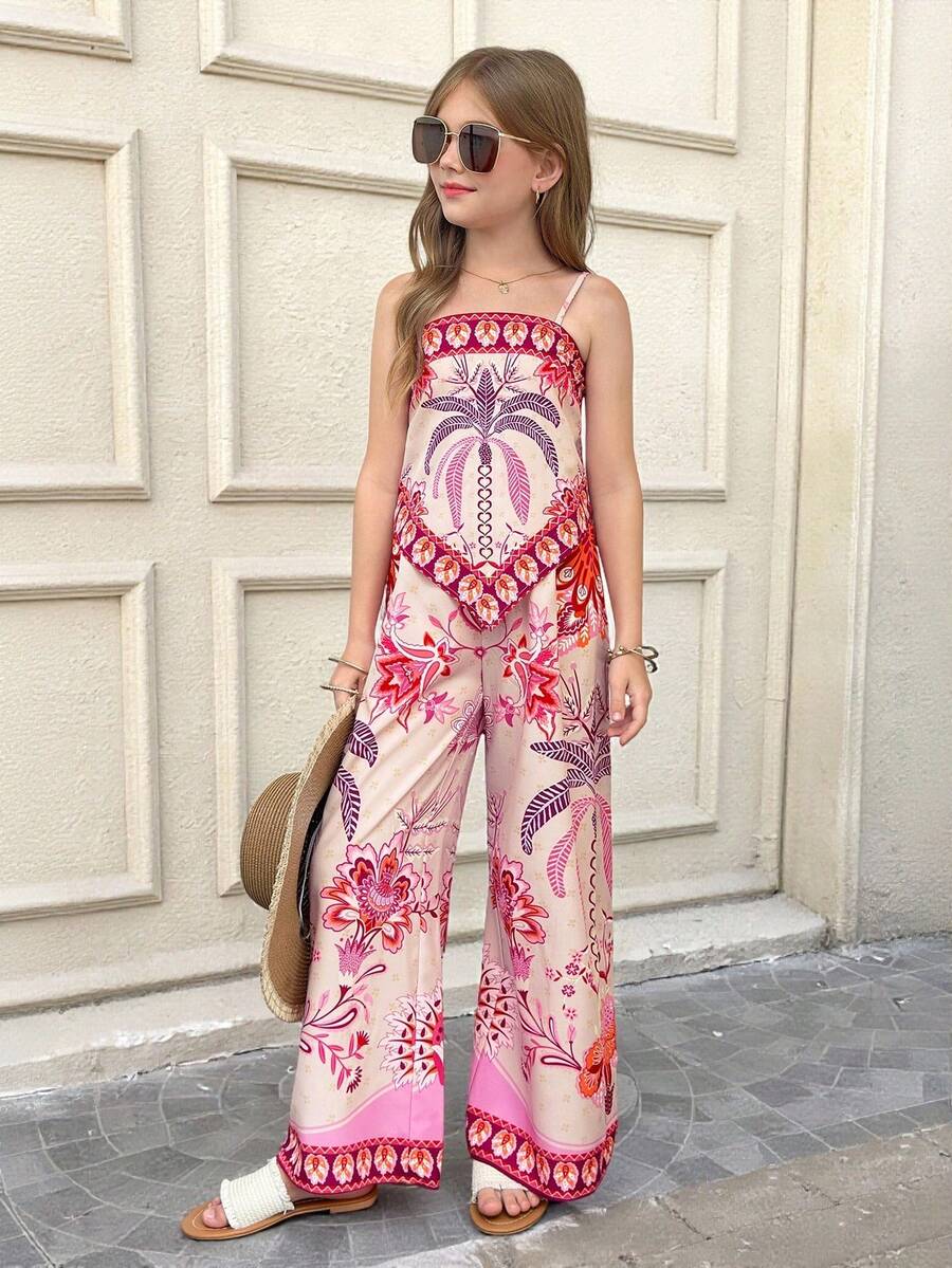 Tween girl wearing a pink boho floral printed 2-piece set with a spaghetti strap cami top and matching belted high-waist long pants.