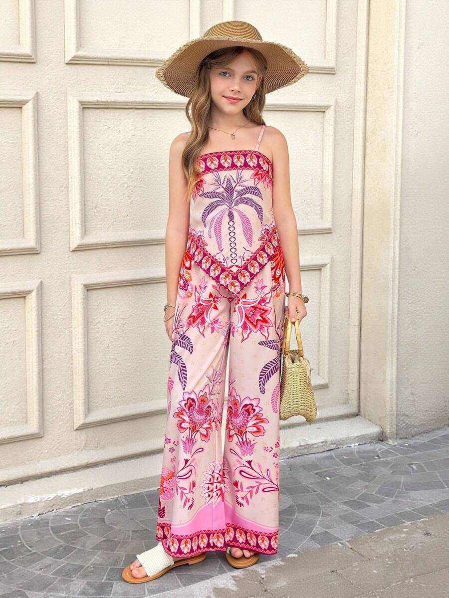 Tween girl wearing a pink boho floral printed 2-piece set with a spaghetti strap cami top and matching belted high-waist long pants.