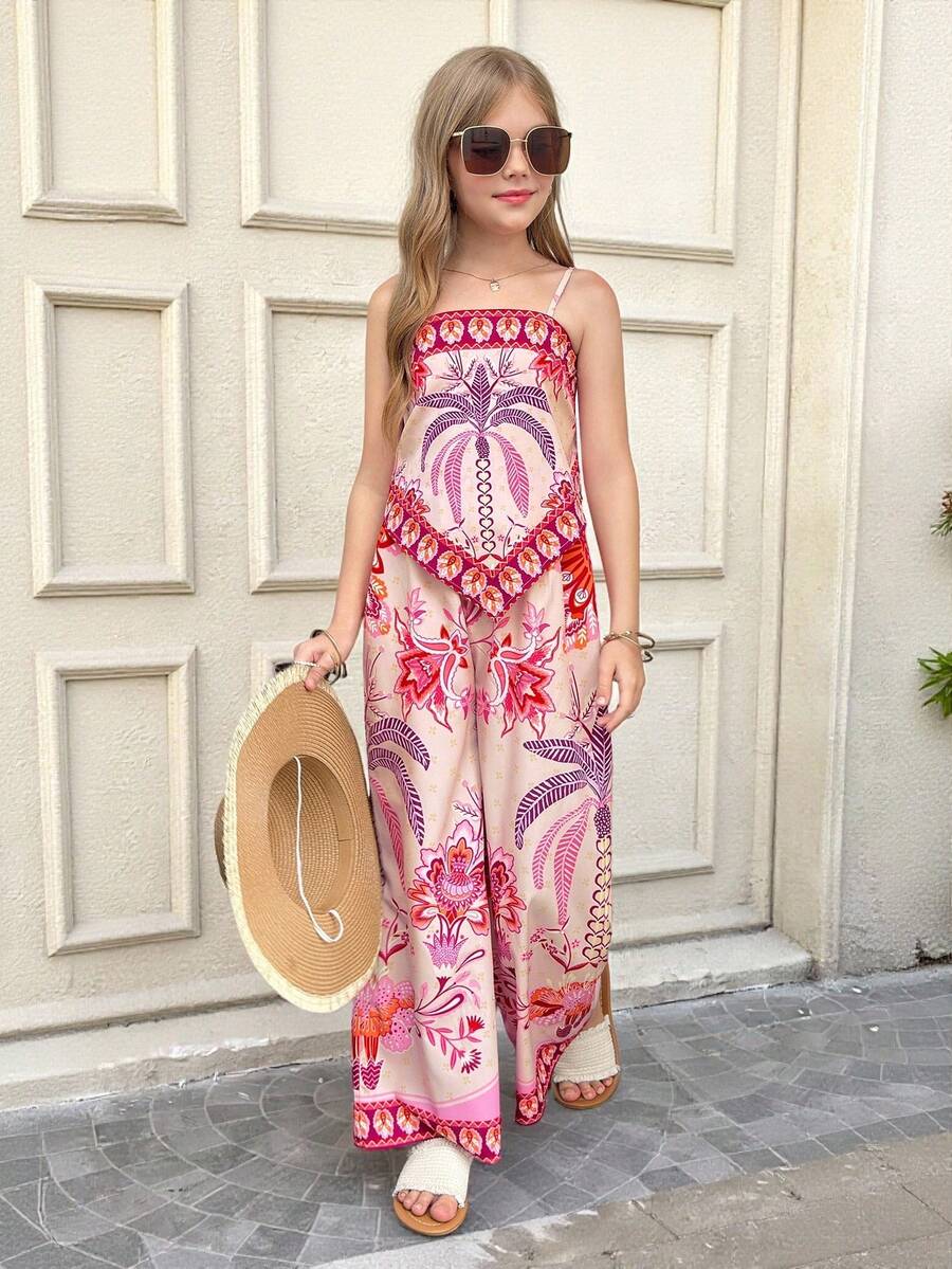 Tween girl wearing a pink boho floral printed 2-piece set with a spaghetti strap cami top and matching belted high-waist long pants.