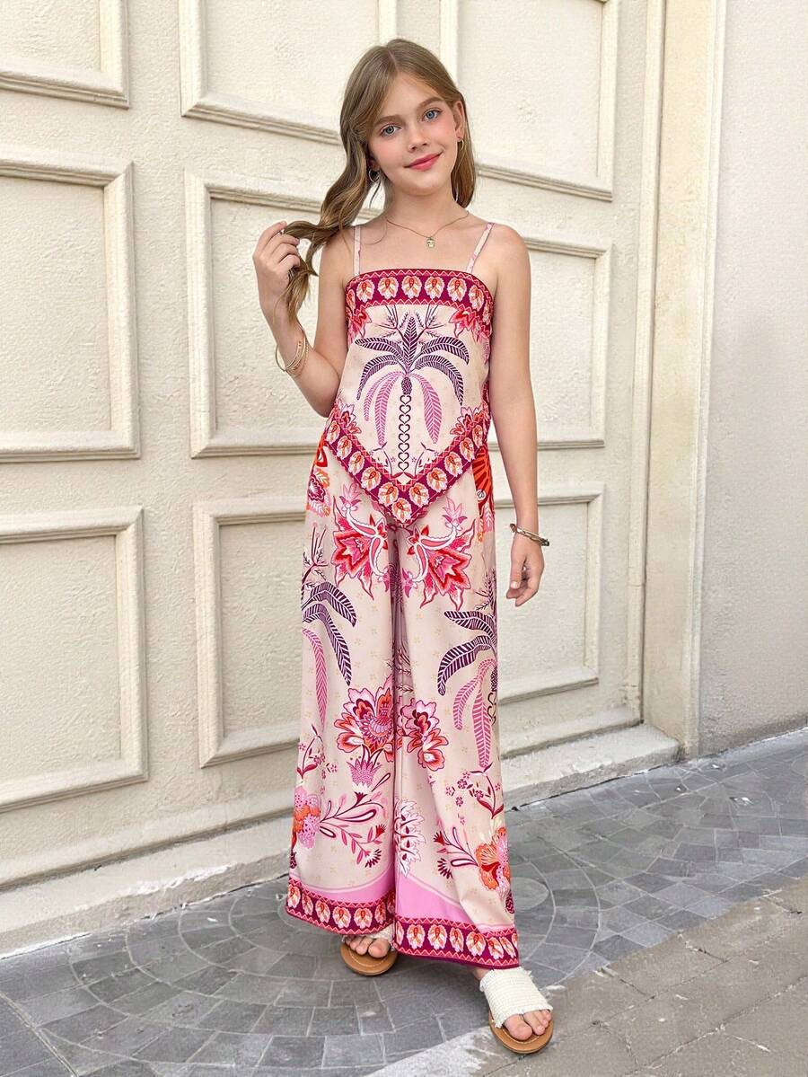 Tween girl wearing a pink boho floral printed 2-piece set with a spaghetti strap cami top and matching belted high-waist long pants.
