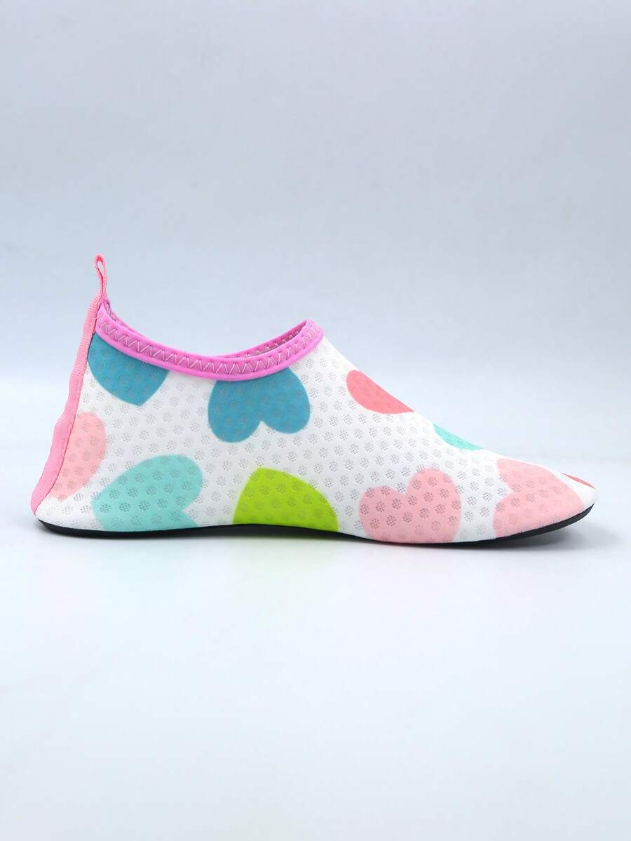 Pair of lightweight slip-on kids water shoes with breathable upper and non-slip outsole for summer beach and pool wear.