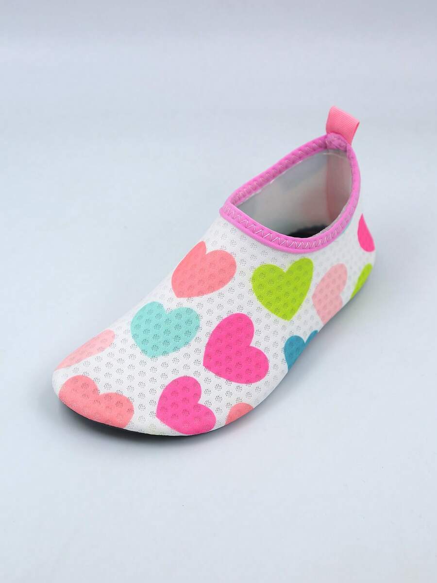 Pair of lightweight slip-on kids water shoes with breathable upper and non-slip outsole for summer beach and pool wear.