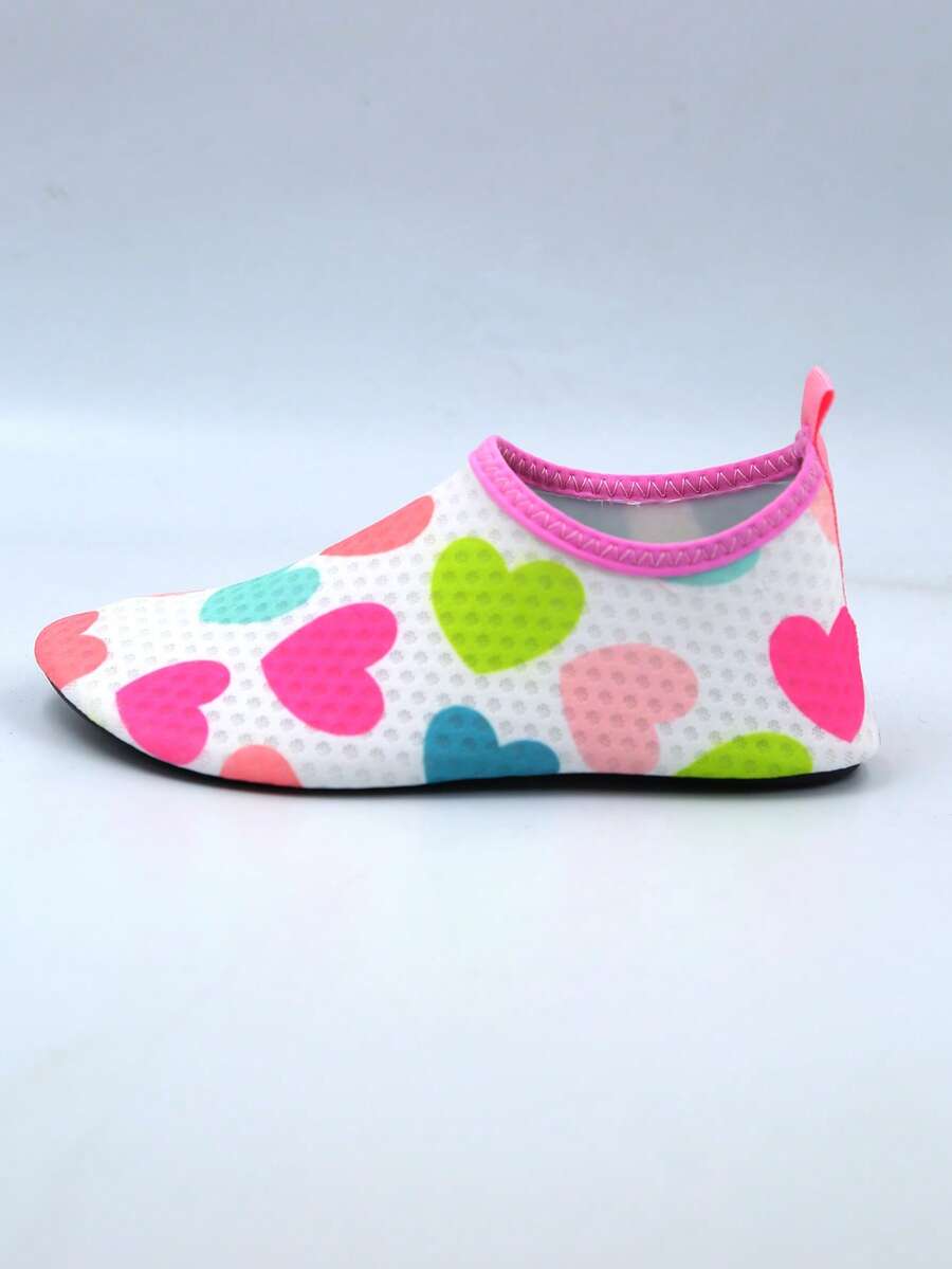 Pair of lightweight slip-on kids water shoes with breathable upper and non-slip outsole for summer beach and pool wear.
