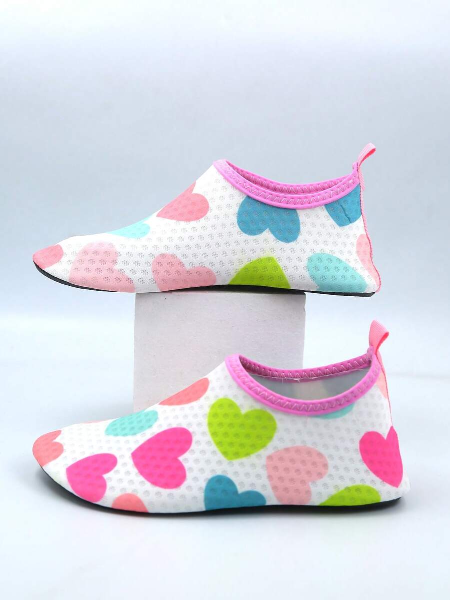 Pair of lightweight slip-on kids water shoes with breathable upper and non-slip outsole for summer beach and pool wear.