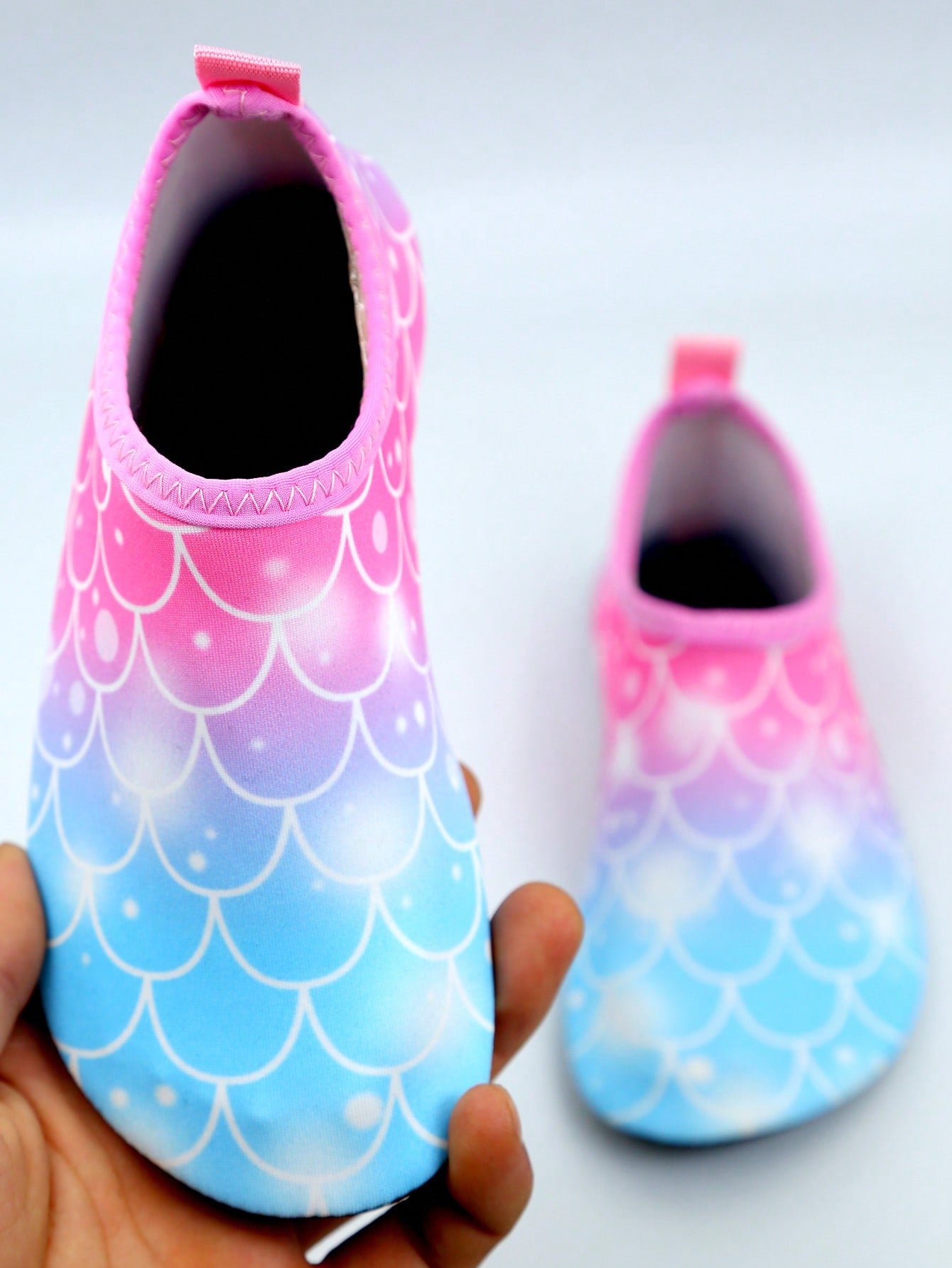 Kids slip-on aqua socks water shoes with breathable polyester upper and non-slip wear-resistant TPR outsole for boys and girls.