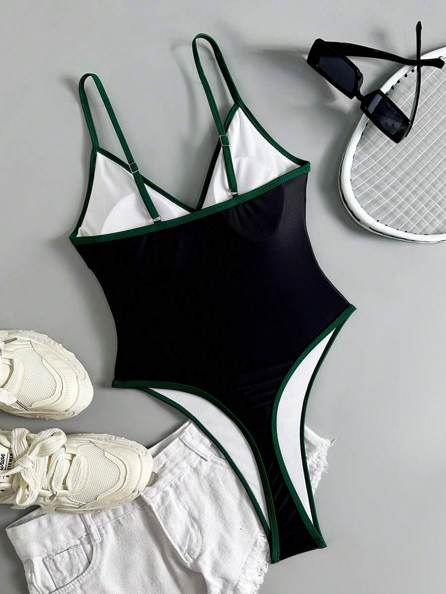 Multicolor printed high cut one-piece swimsuit for women featuring a halter neck, backless lace-up detail, and contrast binding.