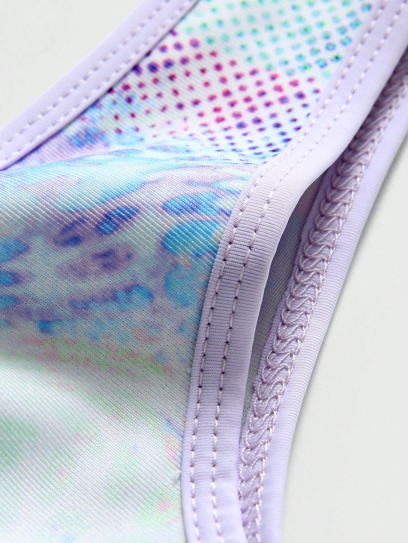 Multicolor tie-dye one-piece swimsuit for tween girls with scoop neck, wireless bra, mid-waist bottom, and high-stretch fabric