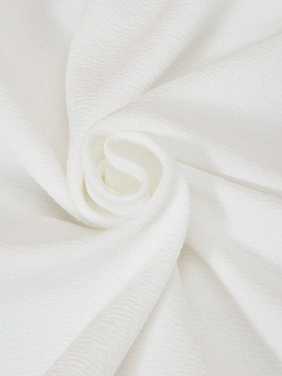Tween girls apricot short-sleeve pleated smock dress with 3D bow decor and round neckline.
