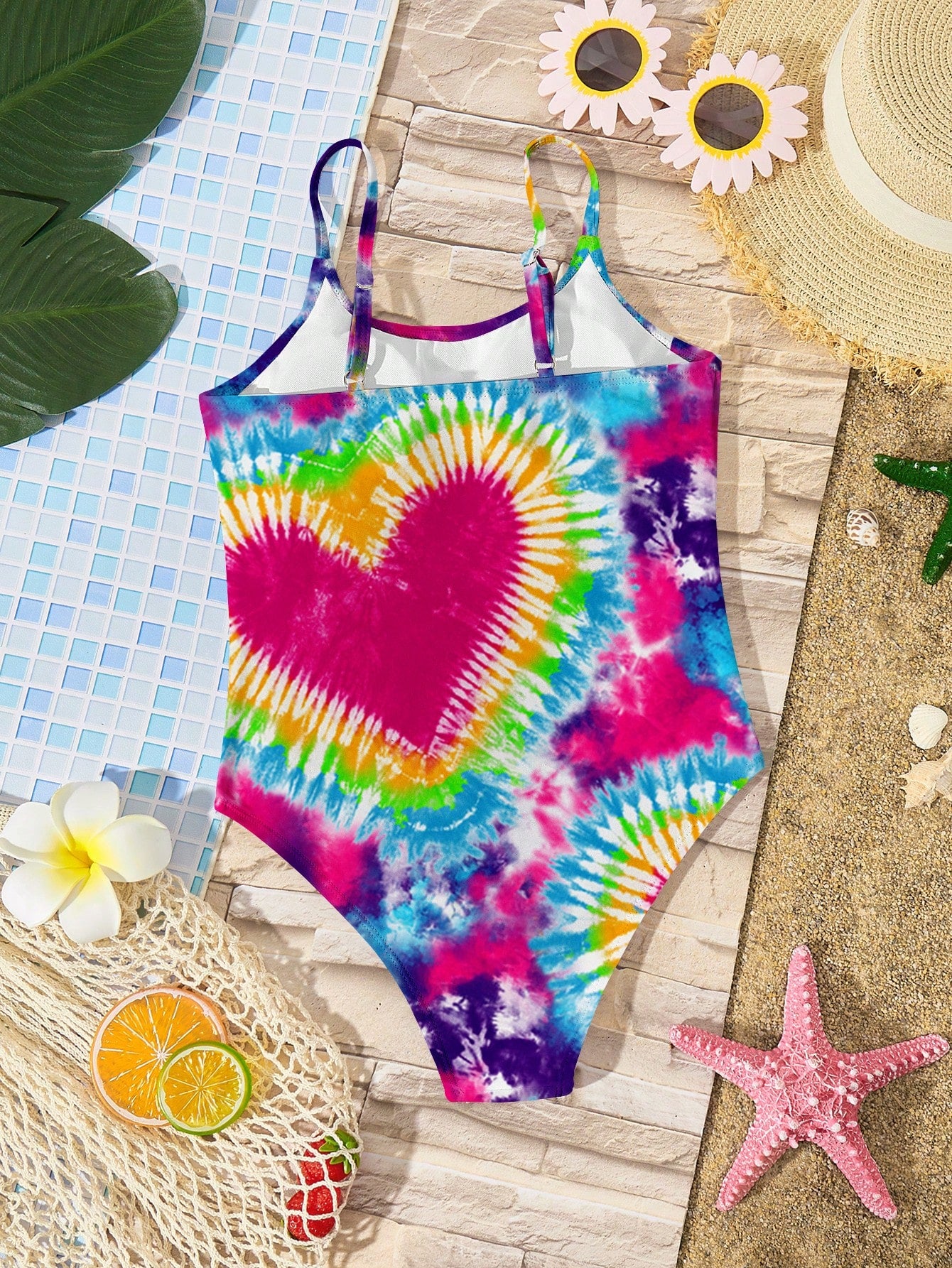 Tween girls multicolor one-piece swimsuit with cut-out detail, spaghetti straps, all-over tie-dye style print, and natural mid-waist bottom for beach and vacation wear.