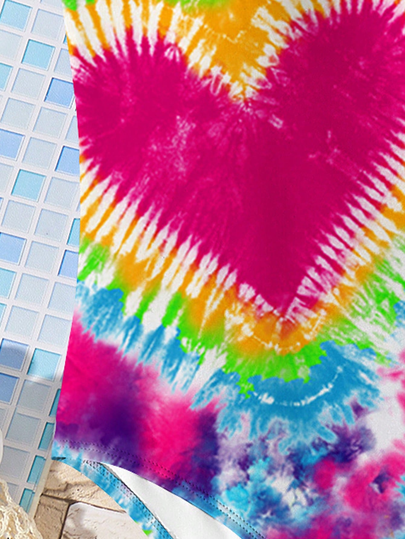 Tween girls multicolor one-piece swimsuit with cut-out detail, spaghetti straps, all-over tie-dye style print, and natural mid-waist bottom for beach and vacation wear.