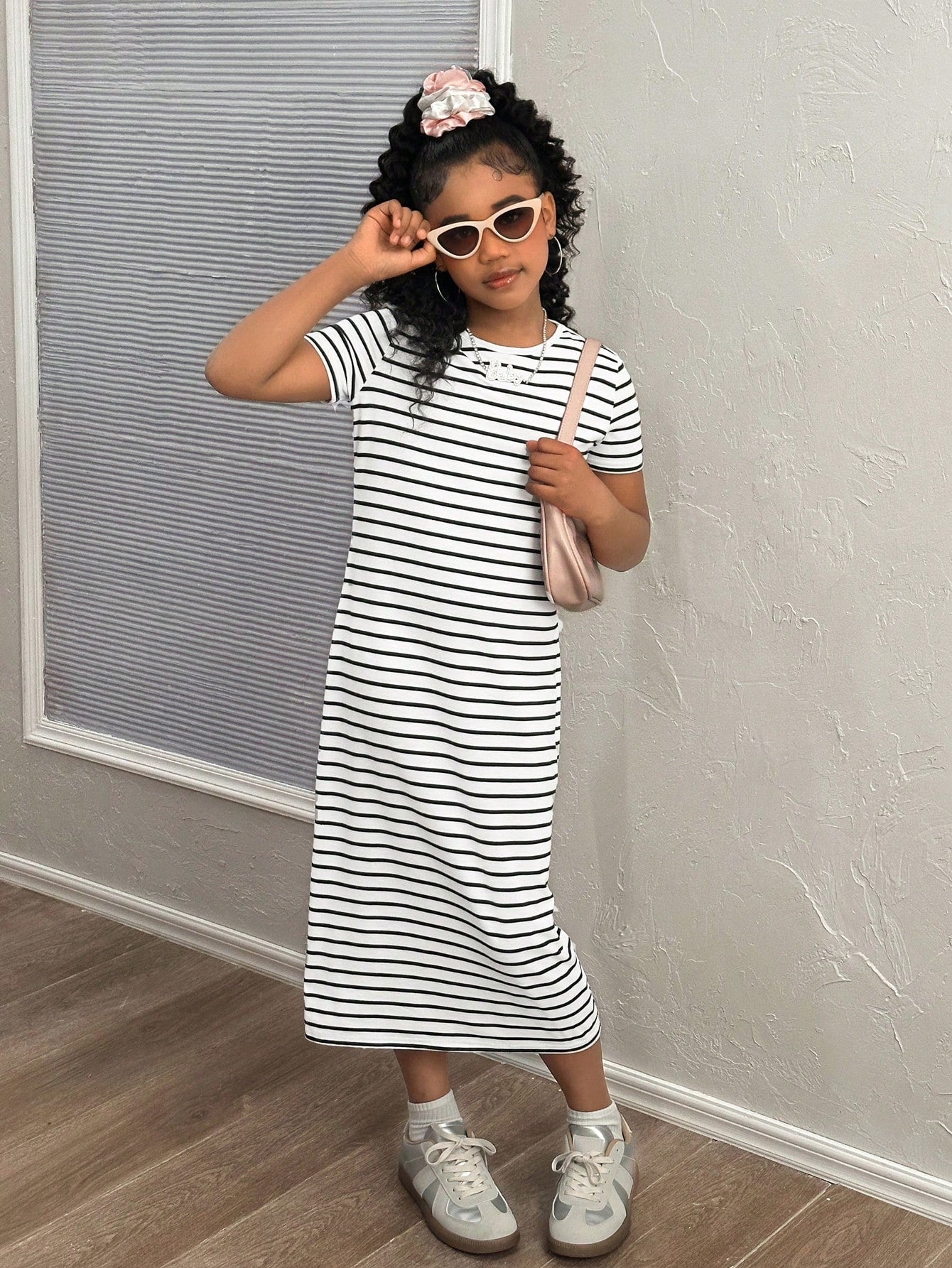 Black and white striped long casual dress for tween girls featuring a round neck, short sleeves, side split, and side pockets.