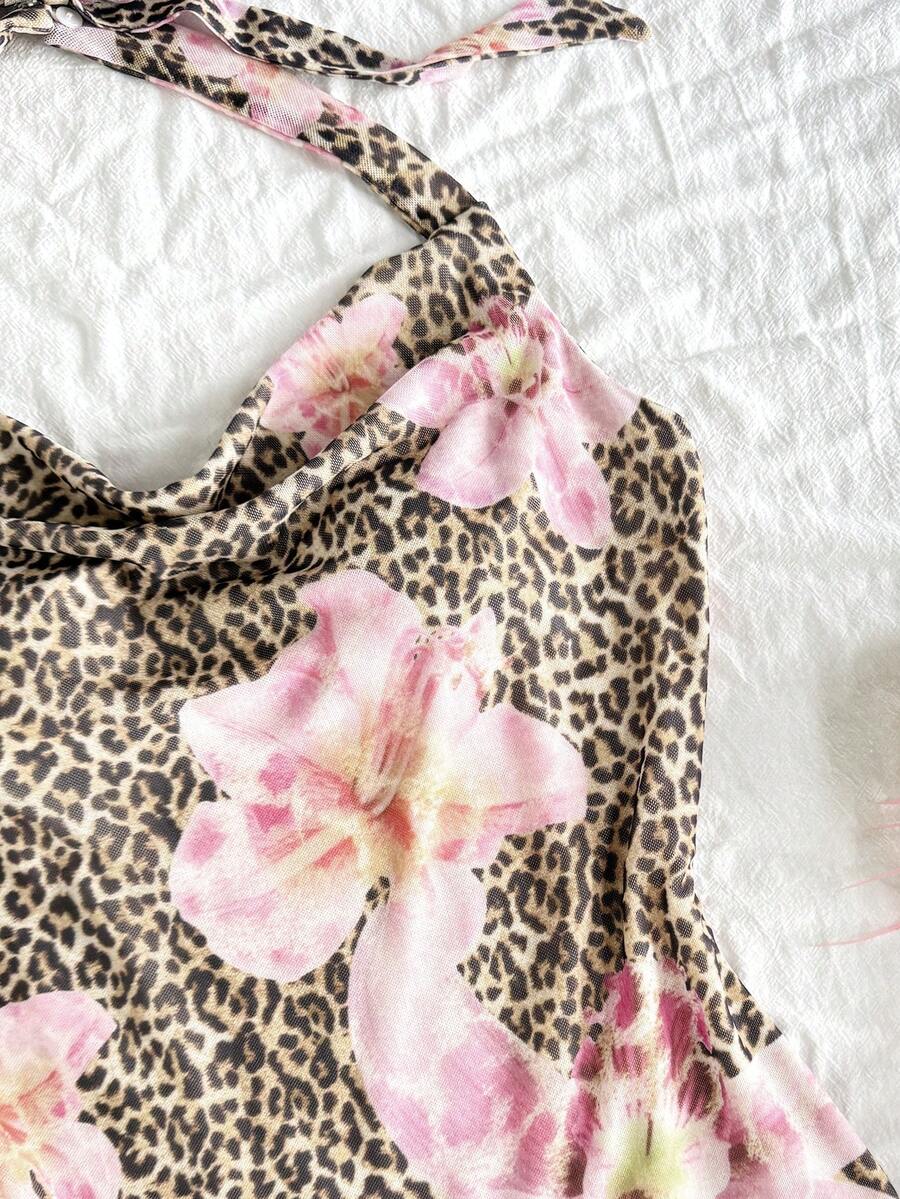 Tween girls sleeveless halter mini dress with ruffle tiered details, flounce hem, slim fit, lined body, and vacation-inspired plant print in khaki and pink tones.