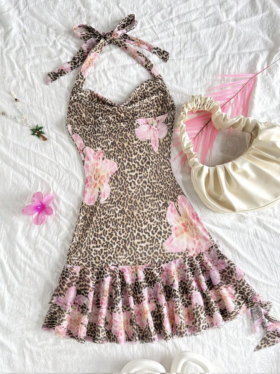 Tween girls sleeveless halter mini dress with ruffle tiered details, flounce hem, slim fit, lined body, and vacation-inspired plant print in khaki and pink tones.