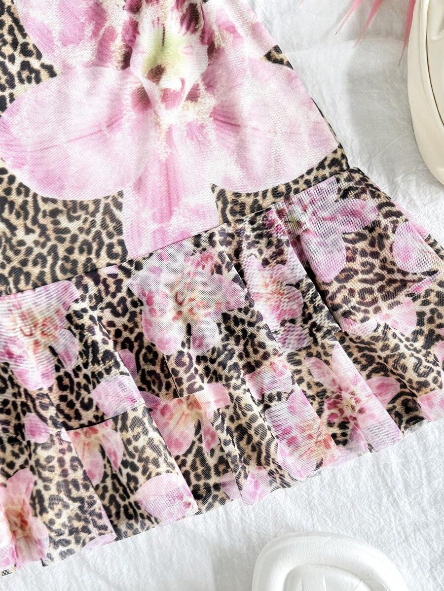 Tween girls sleeveless halter mini dress with ruffle tiered details, flounce hem, slim fit, lined body, and vacation-inspired plant print in khaki and pink tones.