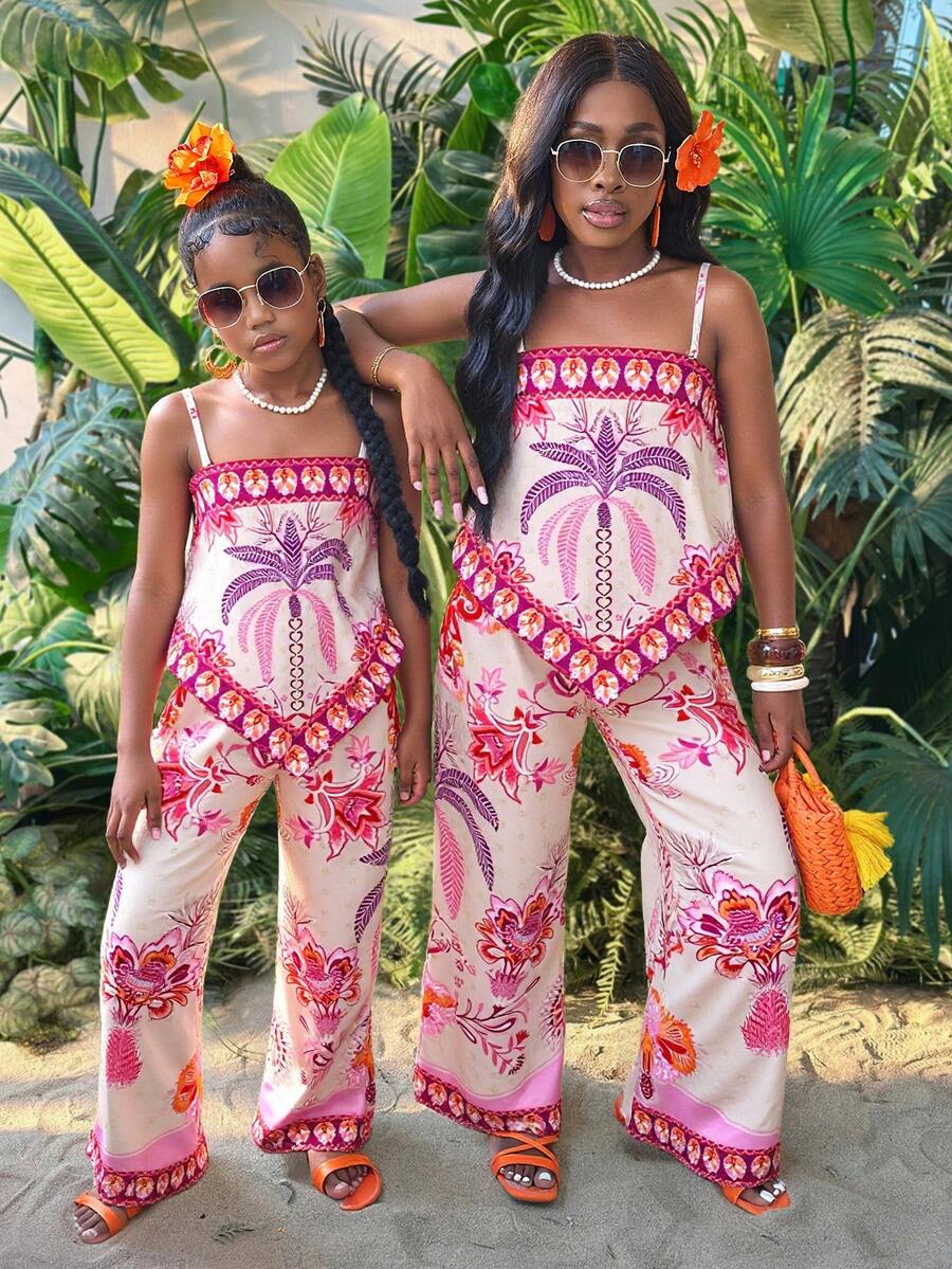 Tween girl wearing a pink boho floral printed 2-piece set with a spaghetti strap cami top and matching belted high-waist long pants.