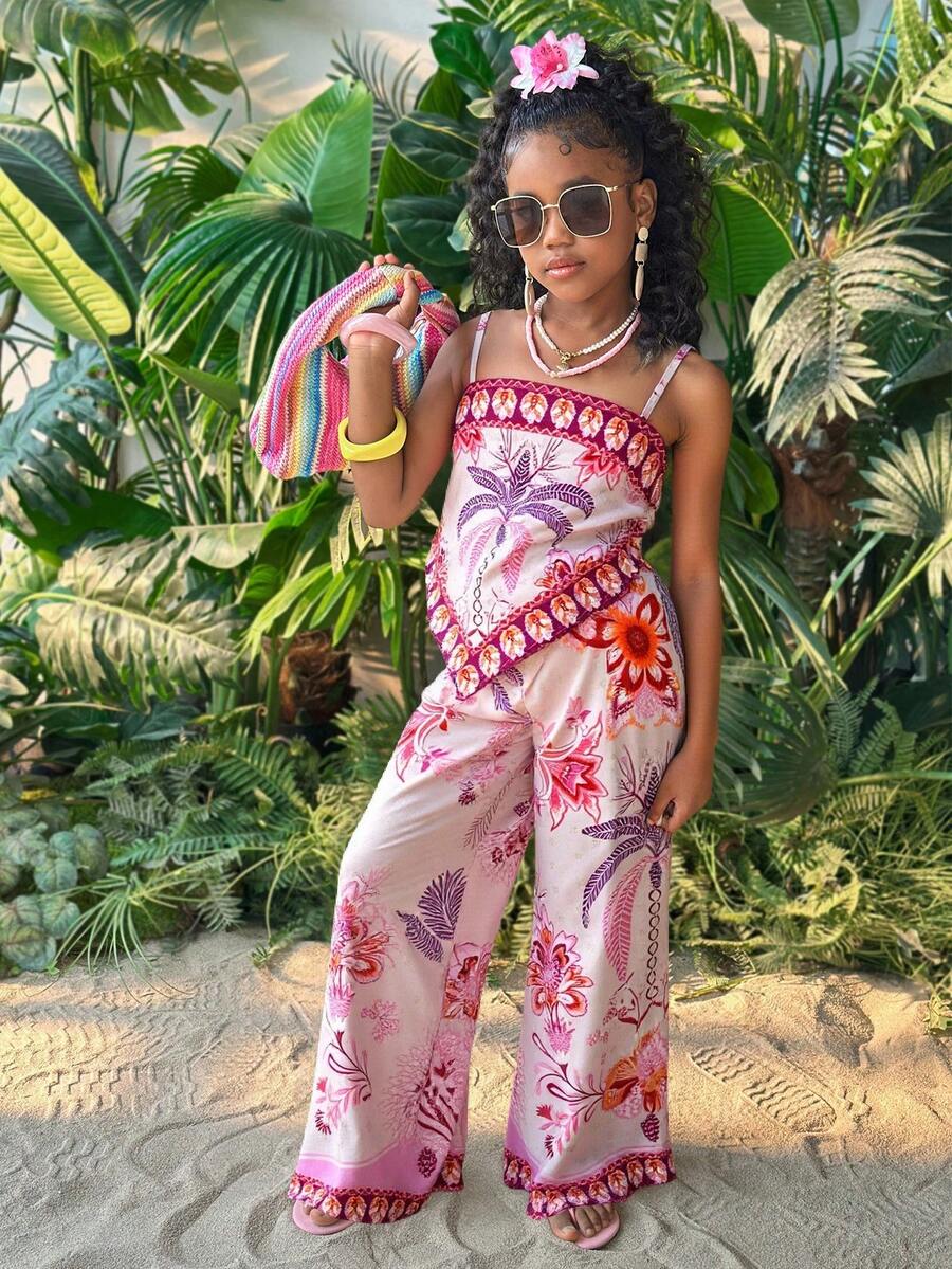 Tween girl wearing a pink boho floral printed 2-piece set with a spaghetti strap cami top and matching belted high-waist long pants.