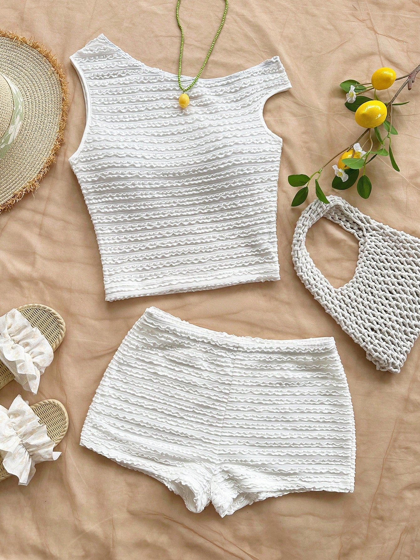 Tween girls 2-piece summer clothing set featuring a black asymmetric rib-knit striped off-shoulder t-shirt and matching slim fit shorts.