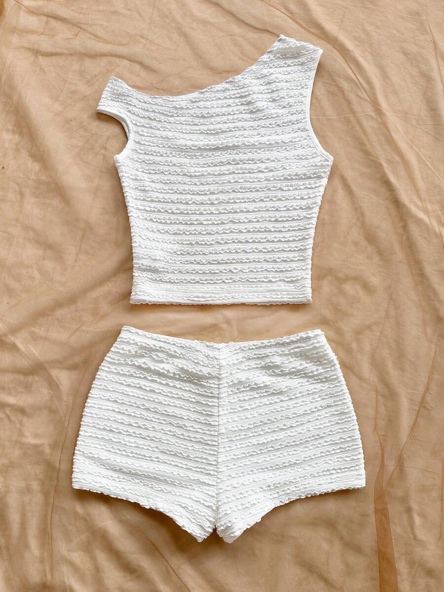 Tween girls 2-piece summer clothing set featuring a black asymmetric rib-knit striped off-shoulder t-shirt and matching slim fit shorts.