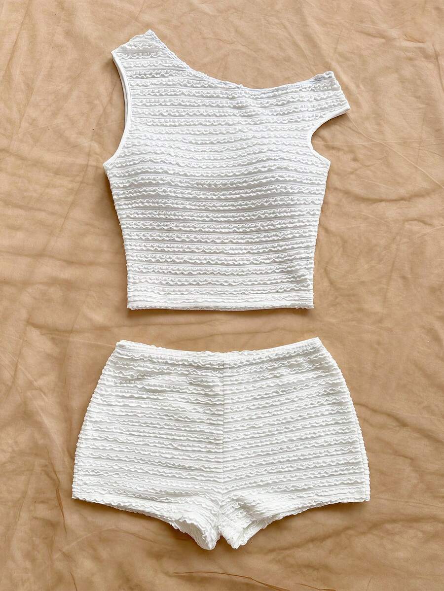 Tween girls 2-piece summer clothing set featuring a black asymmetric rib-knit striped off-shoulder t-shirt and matching slim fit shorts.