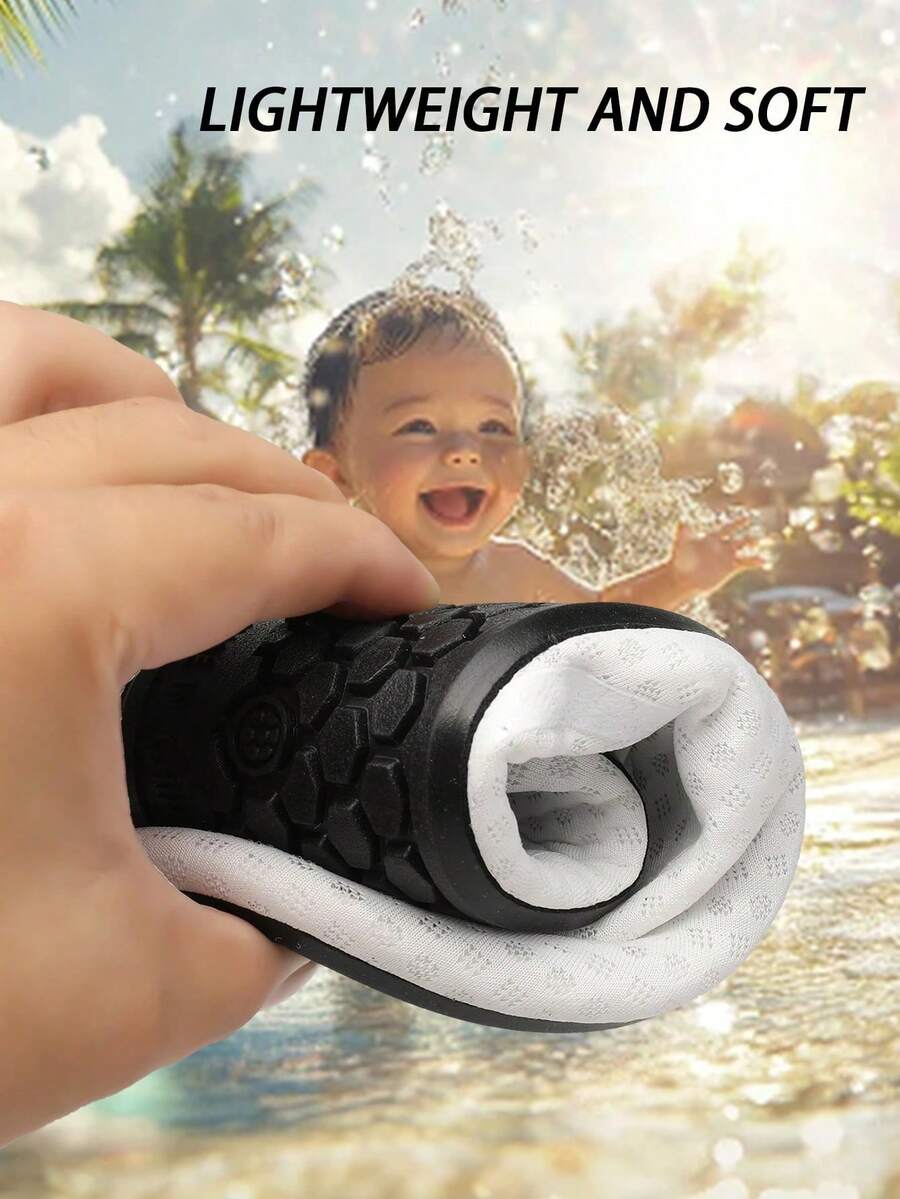 Black slip-on kids water shoes with a graphic pattern fabric upper and wear-resistant rubber outsole for boys and girls.