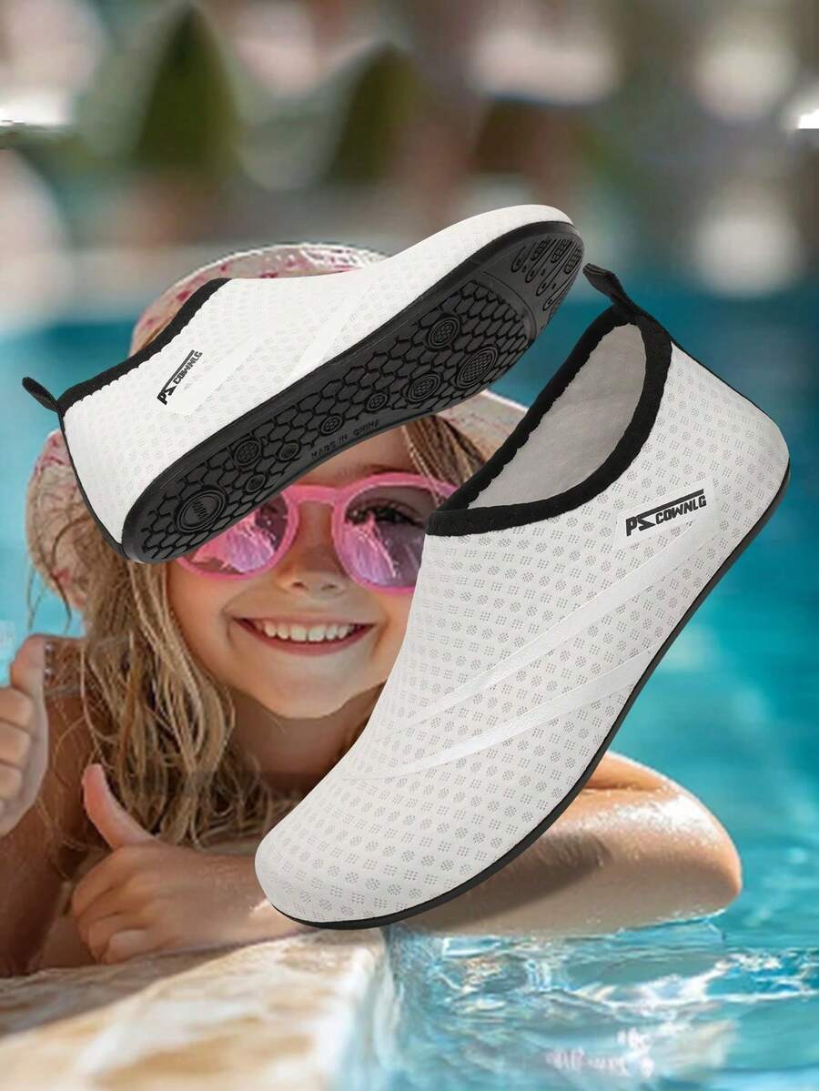 Black slip-on kids water shoes with a graphic pattern fabric upper and wear-resistant rubber outsole for boys and girls.