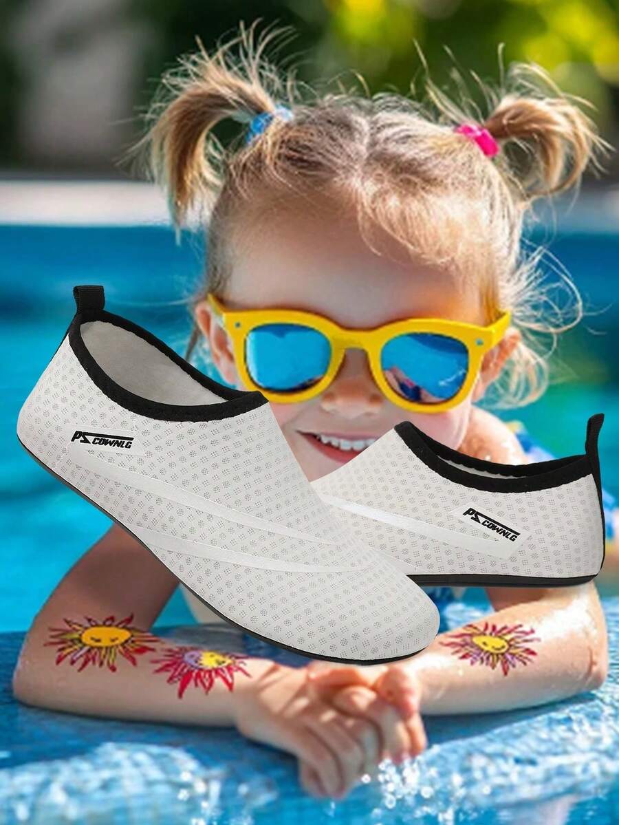 Black slip-on kids water shoes with a graphic pattern fabric upper and wear-resistant rubber outsole for boys and girls.