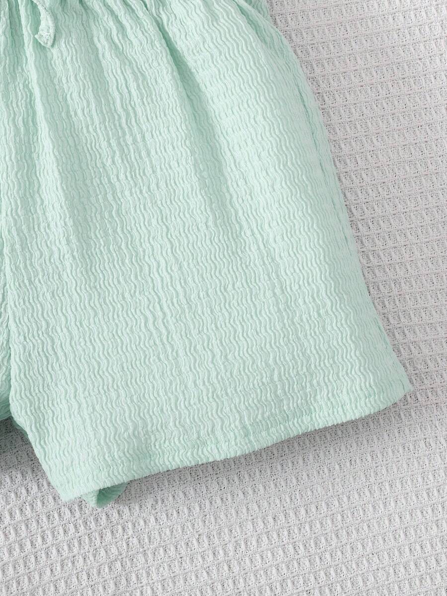 Tween girl 2-piece casual outfit set featuring a solid beige knit halter sleeveless top with belted detail and matching shorts.