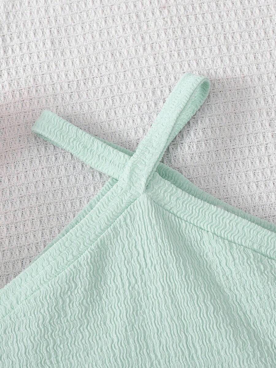 Tween girl 2-piece casual outfit set featuring a solid beige knit halter sleeveless top with belted detail and matching shorts.