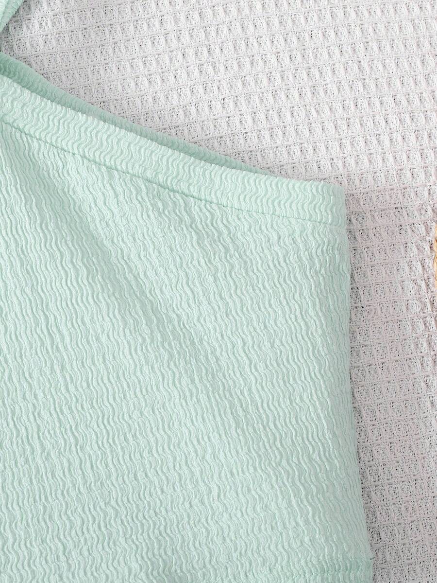 Tween girl 2-piece casual outfit set featuring a solid beige knit halter sleeveless top with belted detail and matching shorts.