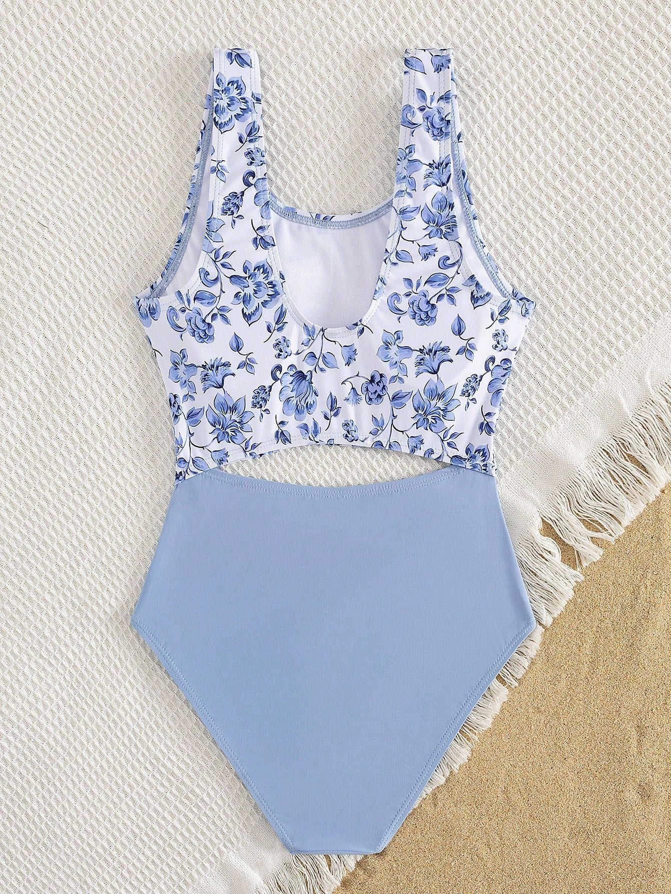 Tween girls blue and white floral one-piece swimsuit with scoop neck, cut-out detail, lined body, and high-stretch fabric for beach and vacation wear.