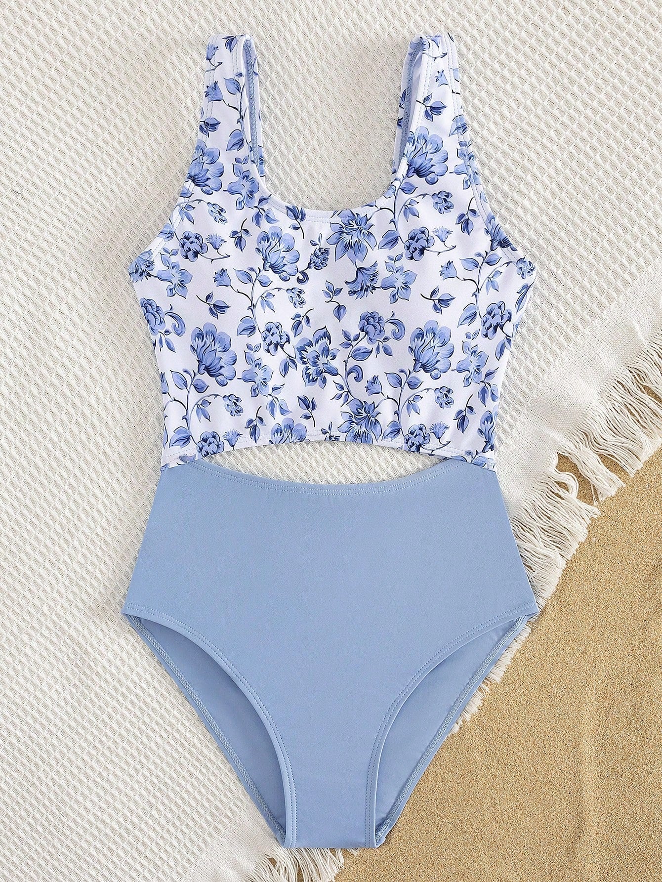 Tween girls blue and white floral one-piece swimsuit with scoop neck, cut-out detail, lined body, and high-stretch fabric for beach and vacation wear.