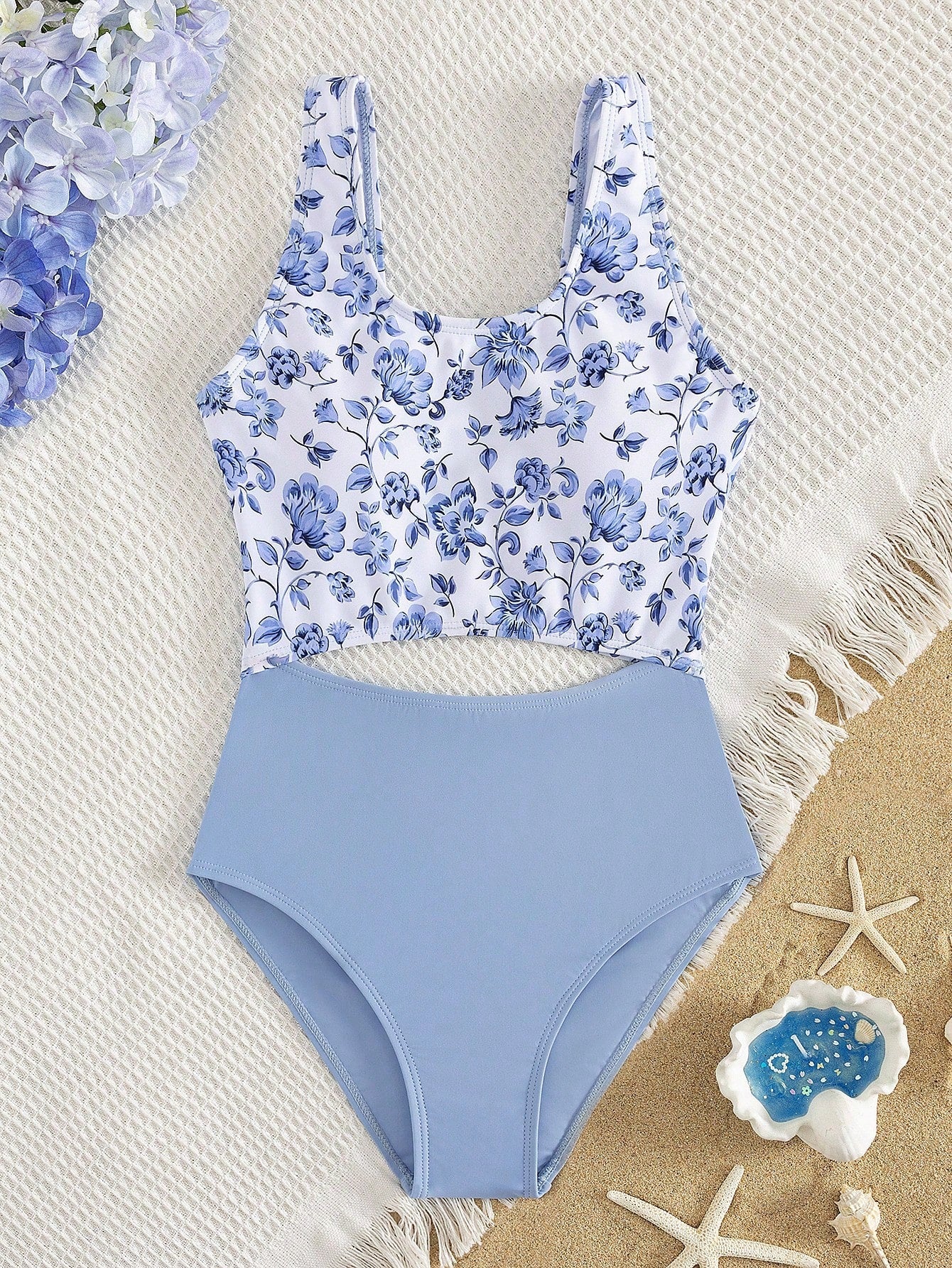 Tween girls blue and white floral one-piece swimsuit with scoop neck, cut-out detail, lined body, and high-stretch fabric for beach and vacation wear.