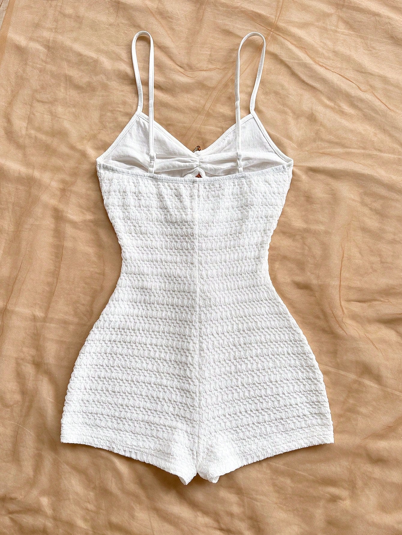 Apricot one-piece swimsuit for tween girls with a halter neckline, ruffle trim, textured knit fabric, fitted shape, and starfish metal decor.