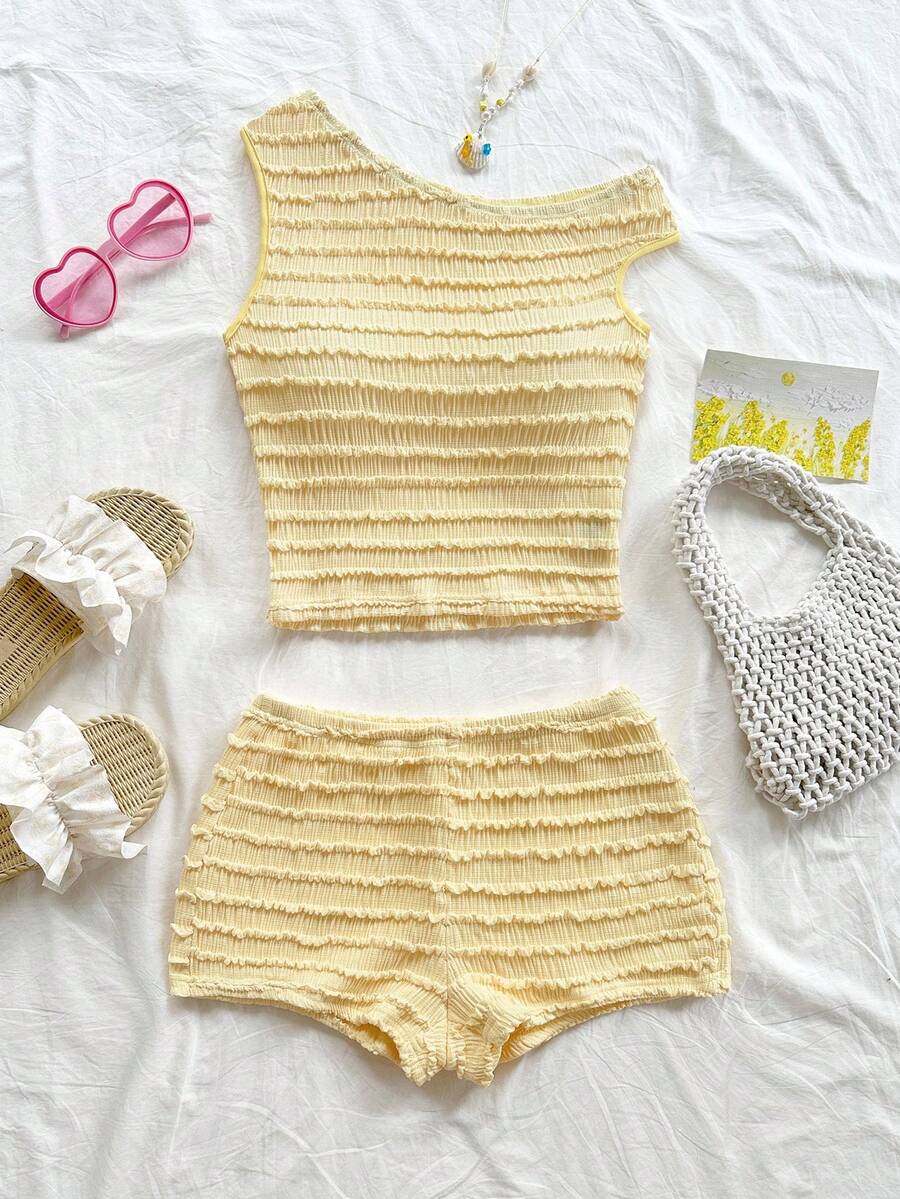 Tween girls 2-piece summer clothing set featuring a black asymmetric rib-knit striped off-shoulder t-shirt and matching slim fit shorts.